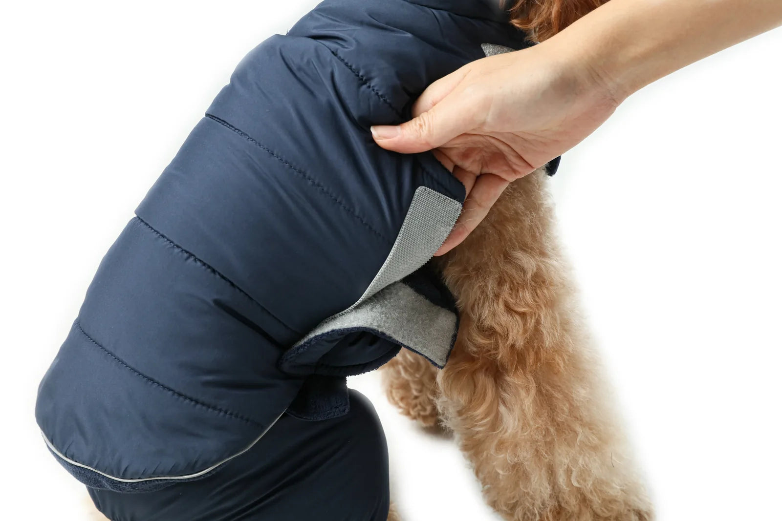Reversible red dog vest jacket with adjustable Velcro closures, designed for warmth and comfort in cold weather.
