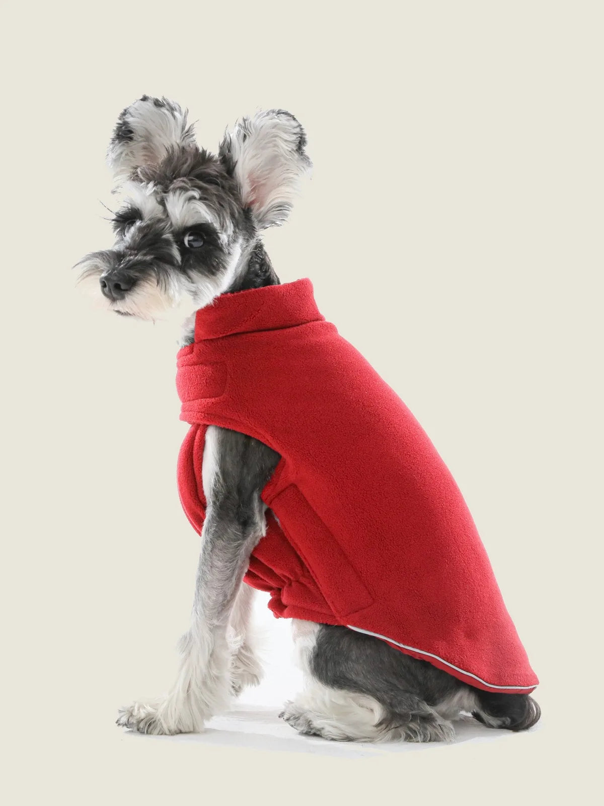 Reversible dog vest jacket in red, made of thick polar fleece with a snug fit and adjustable Velcro closures.