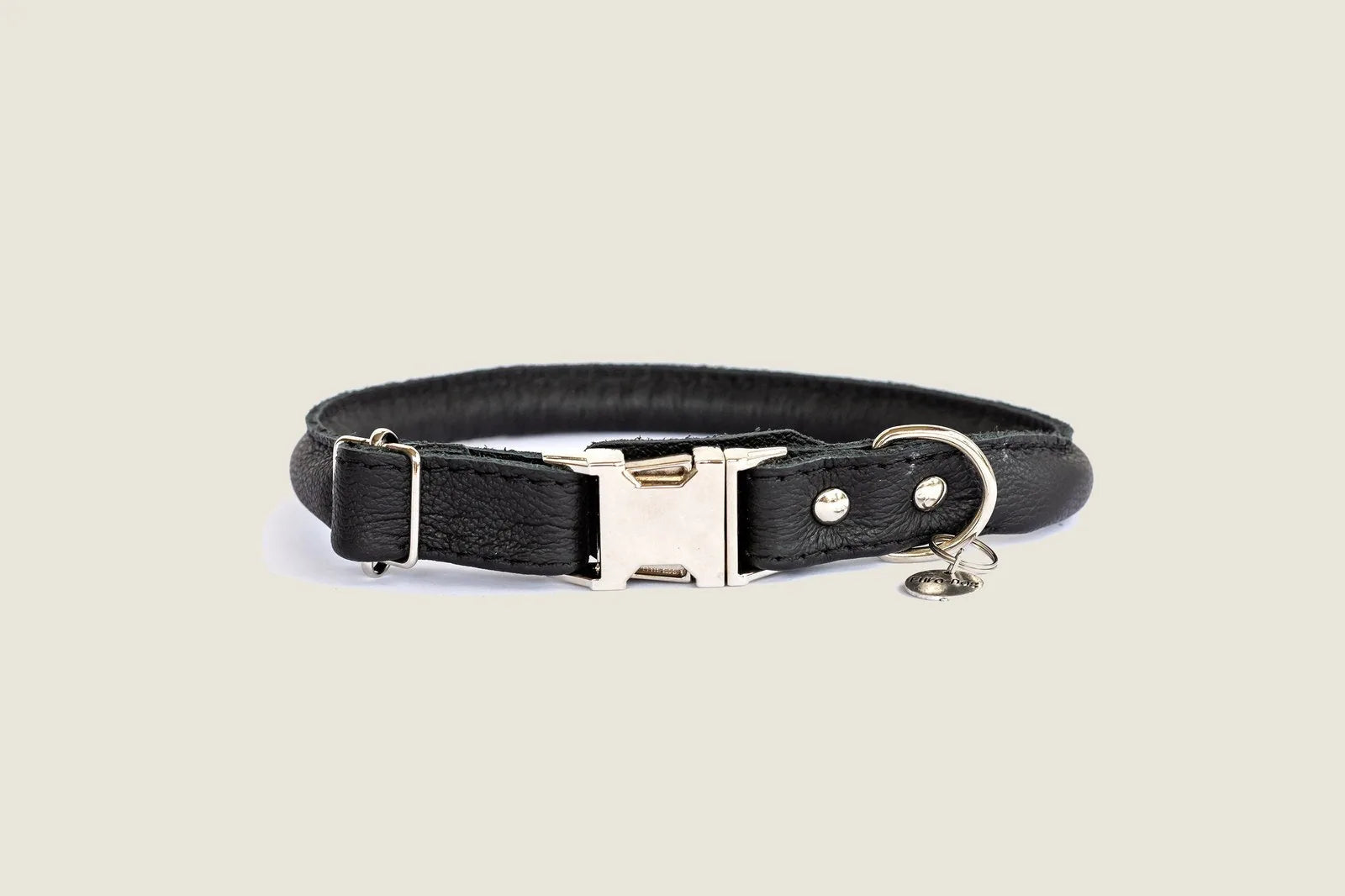 Rolled black leather dog collar featuring a quick-release buckle and fine European steel details.