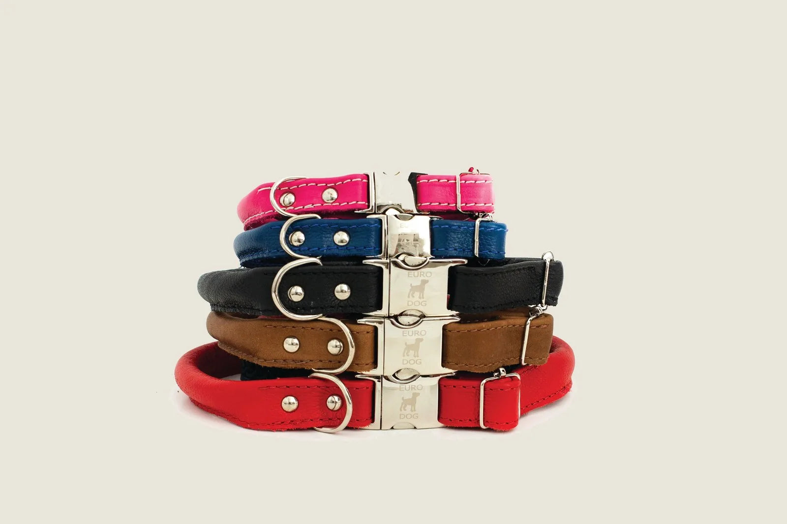 Stacked rolled dog collars in various colors including blue, red, and brown, showcasing silver quick-release buckles and s...
