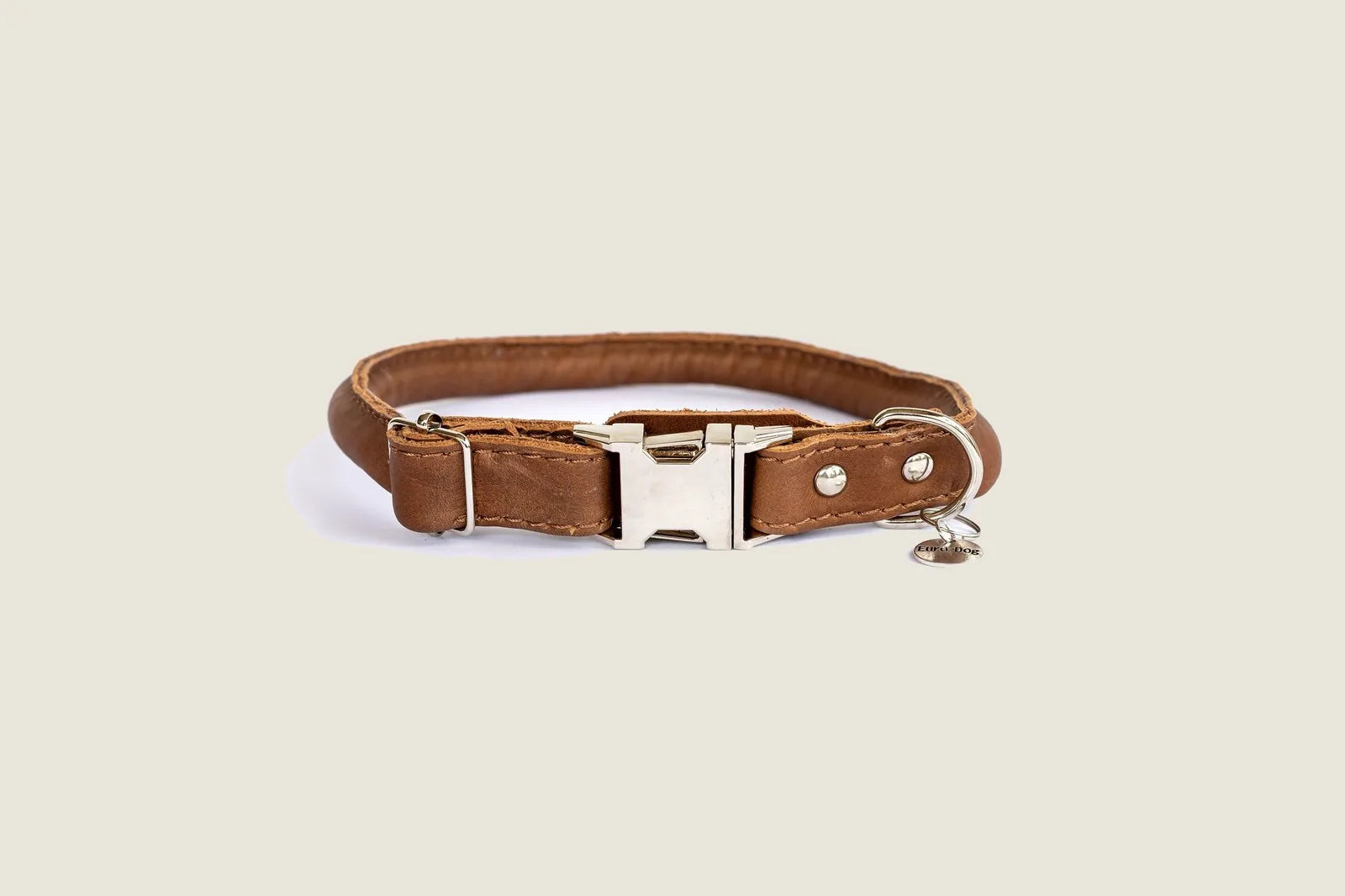 Light brown leather quick-release dog collar featuring polished steel hardware and durable polyester stitching.