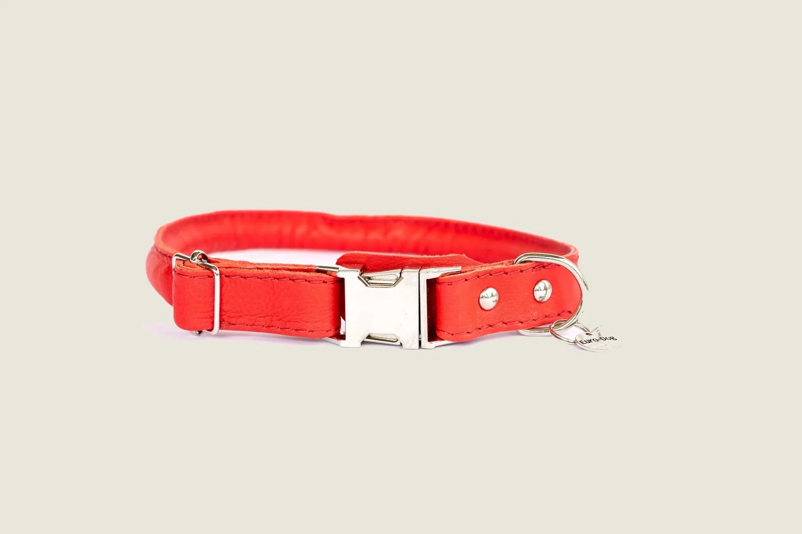 Rolled red leather quick-release dog collar with silver hardware and polyester stitching for added style and comfort.