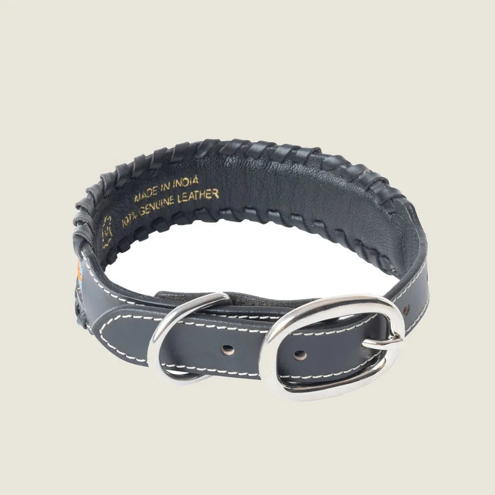 Black leather dog collar featuring a sturdy silver buckle and intricate stitching, showcasing its handcrafted quality.