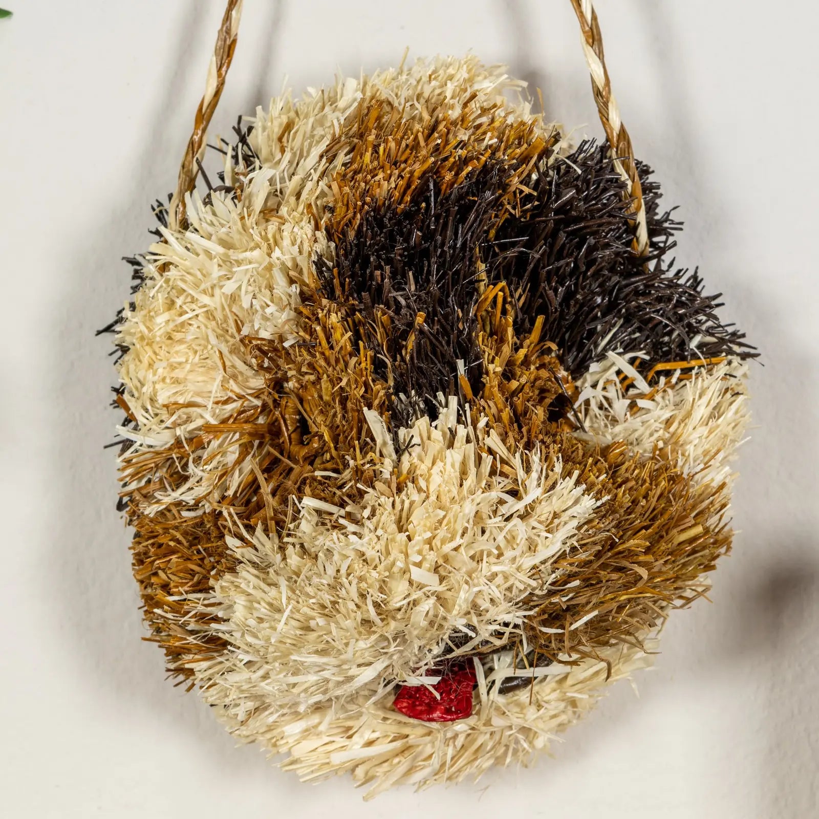 Handwoven Saint Bernard dog mask in natural tones with vibrant texture, enhancing wall decor. Unique artisan craftsmanship.