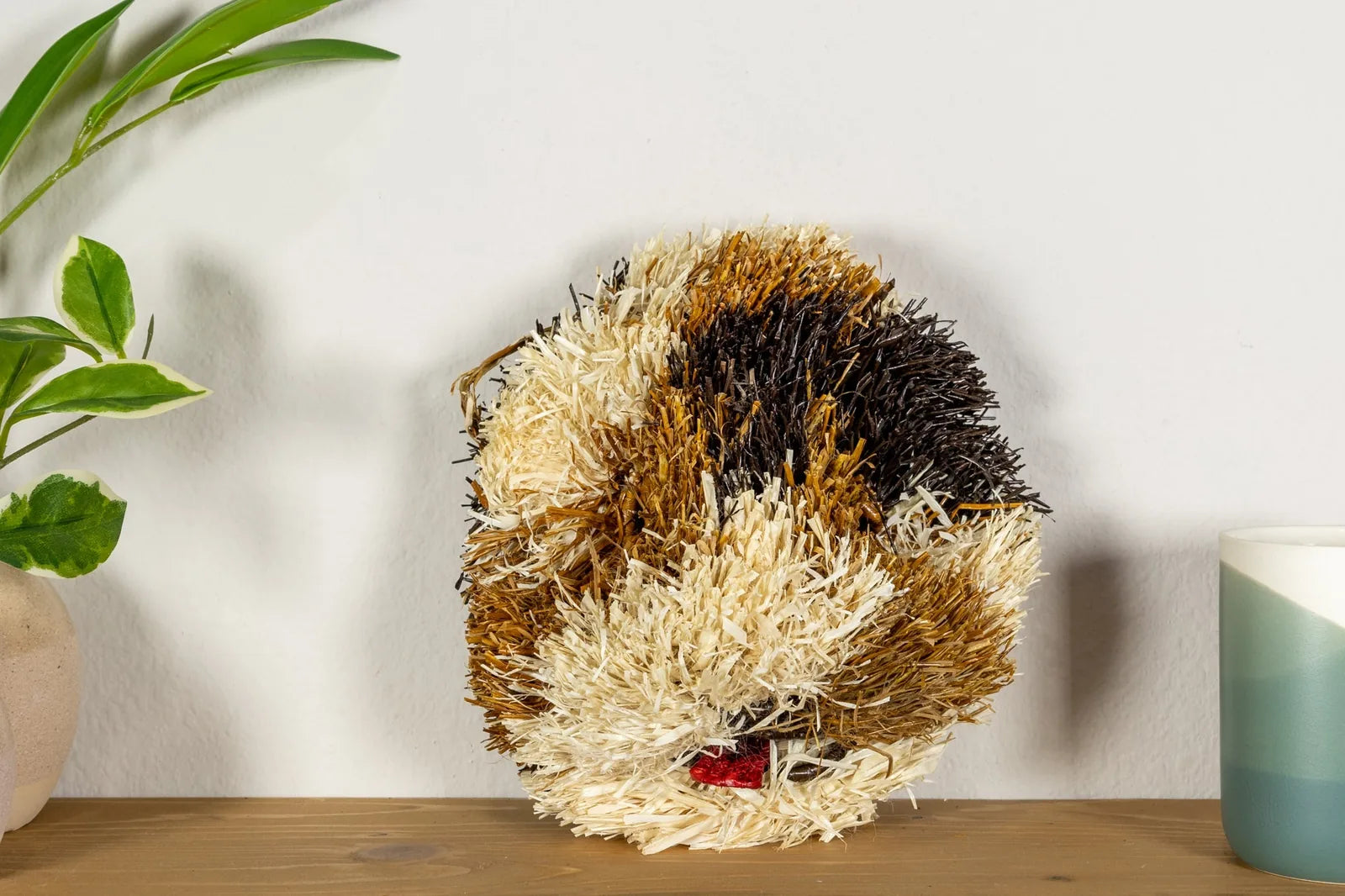 Handwoven Saint Bernard dog mask in earthy tones, adding cultural charm to wall decor; crafted by Indigenous artisans.
