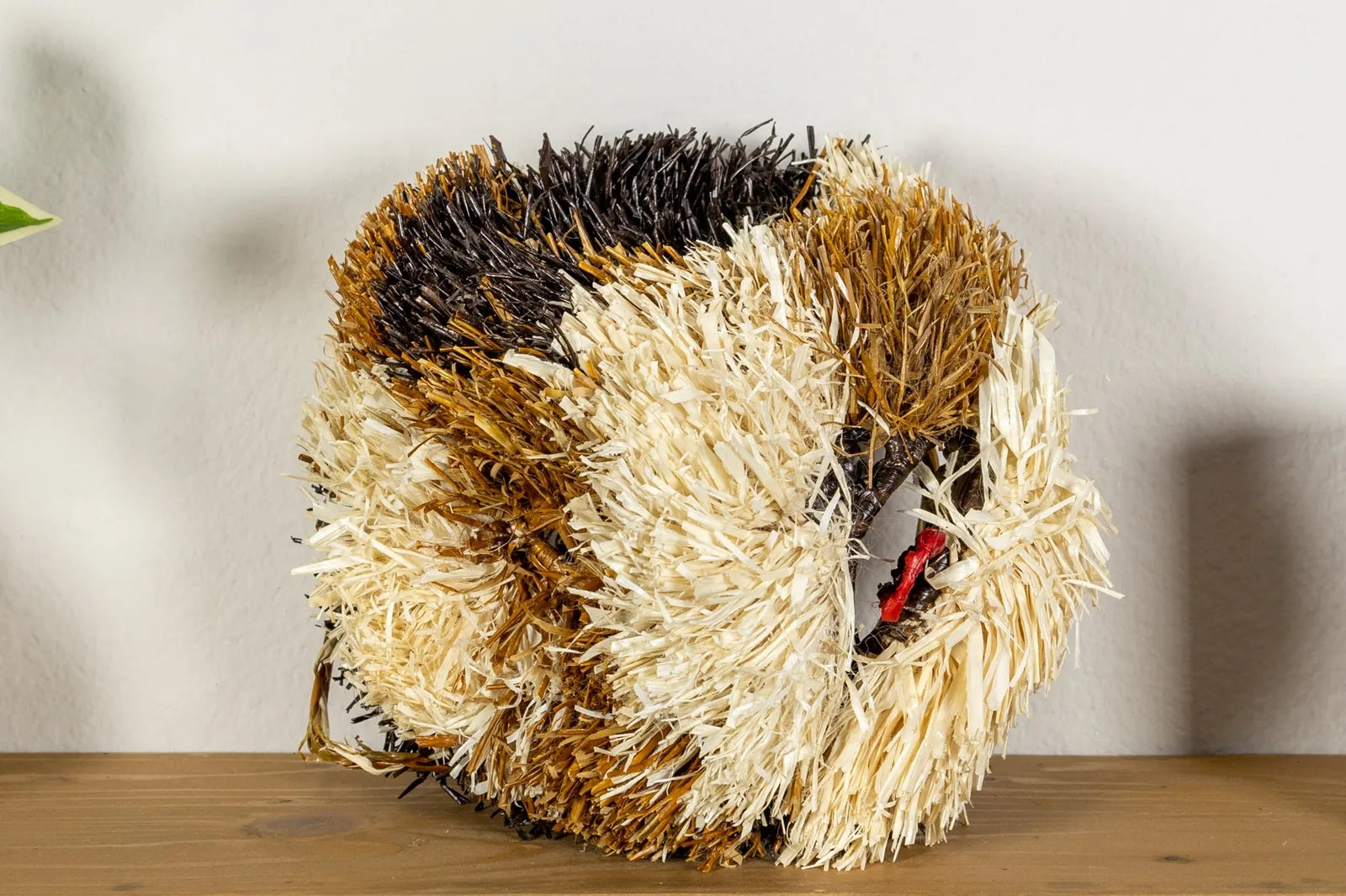 Handwoven Saint Bernard dog mask in vibrant browns and cream, made from natural materials, perfect for wall decor.