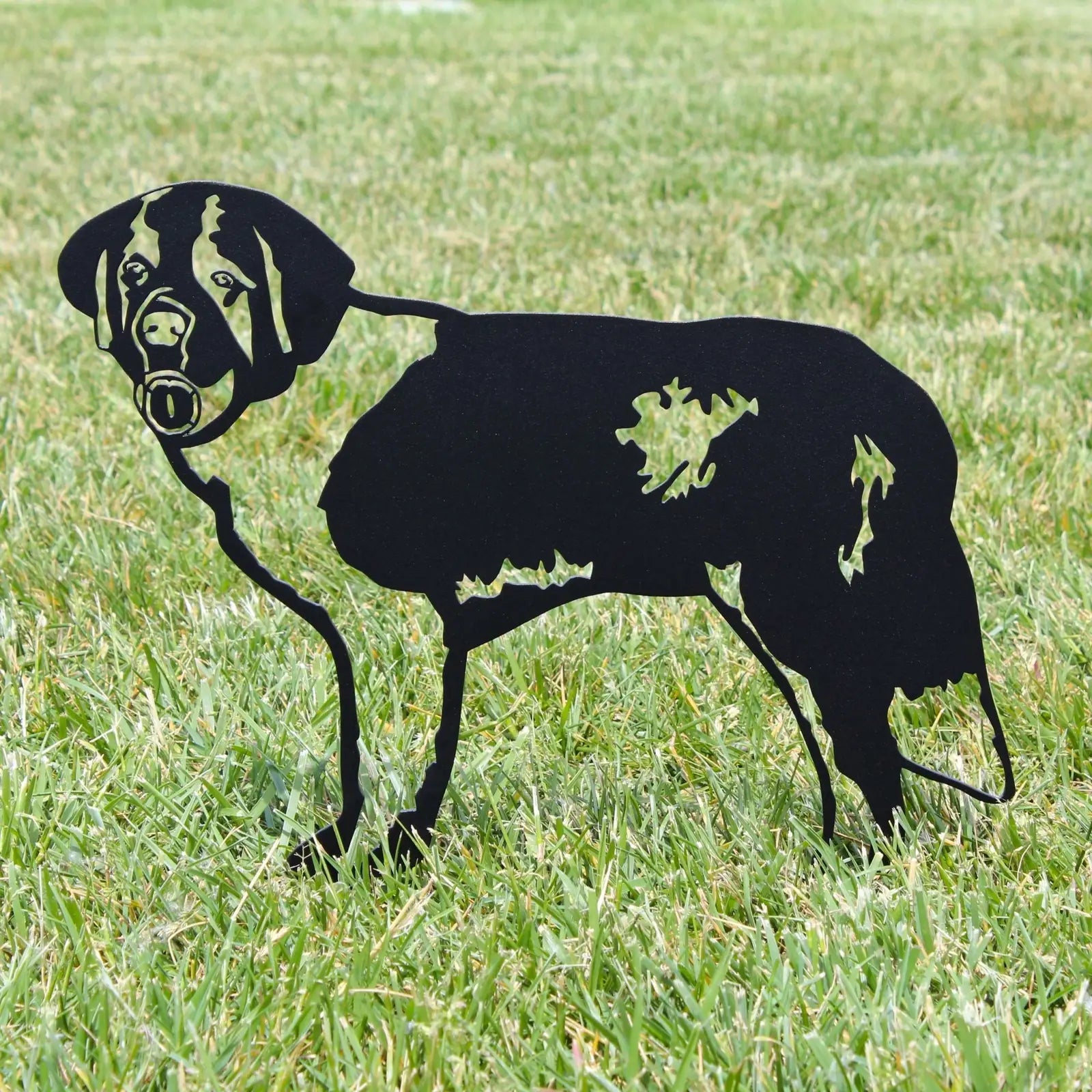 Black metal silhouette of a Saint Bernard standing in grass, showcasing a detailed dog design ideal for outdoor decor.