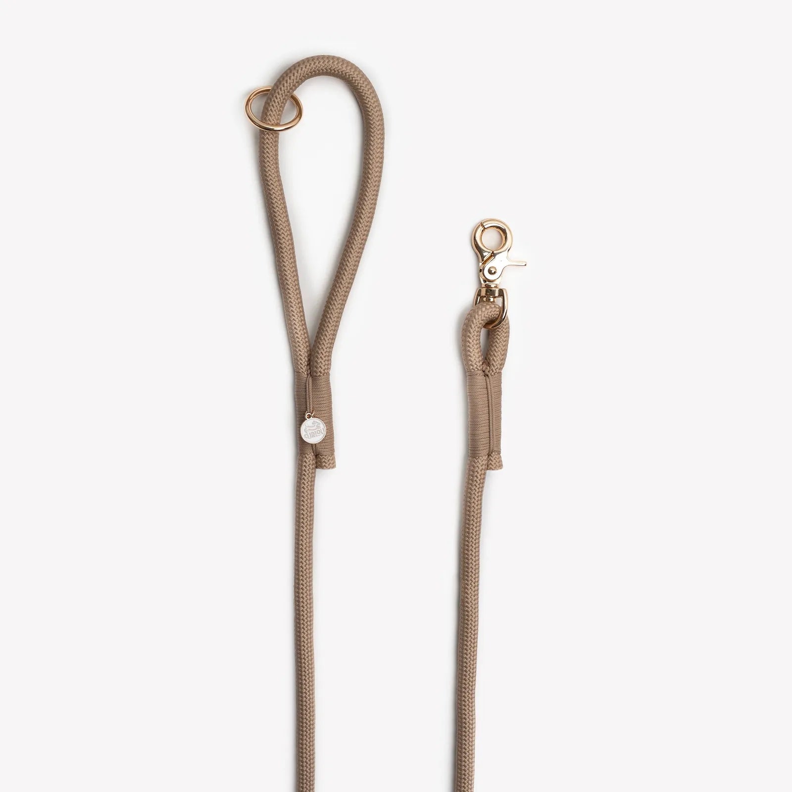 Braided rope leash in sand color, featuring a gold O-ring and clip for easy attachment to accessories and secure walks.