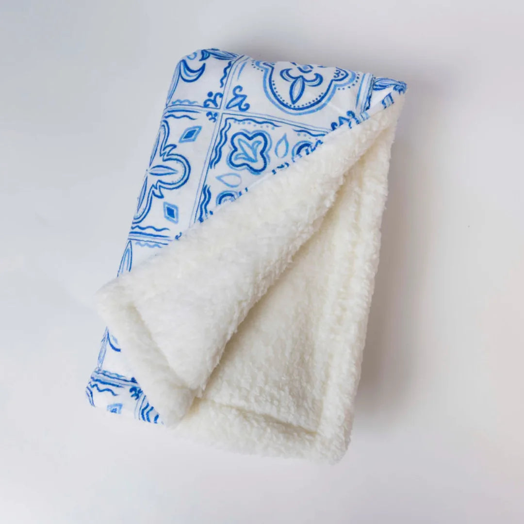 Cozy double-sided Santorini Dog Blanket in blue patterned microfiber and cream sherpa, perfect for small to medium dogs.