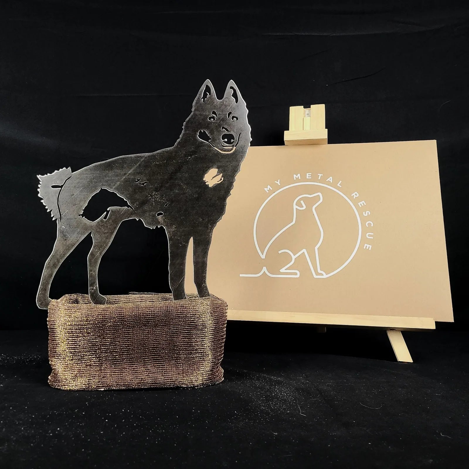 Handcrafted black Schipperke metal silhouette stands on textured base, showcasing rustic dog-themed decor by My Metal Rescue.