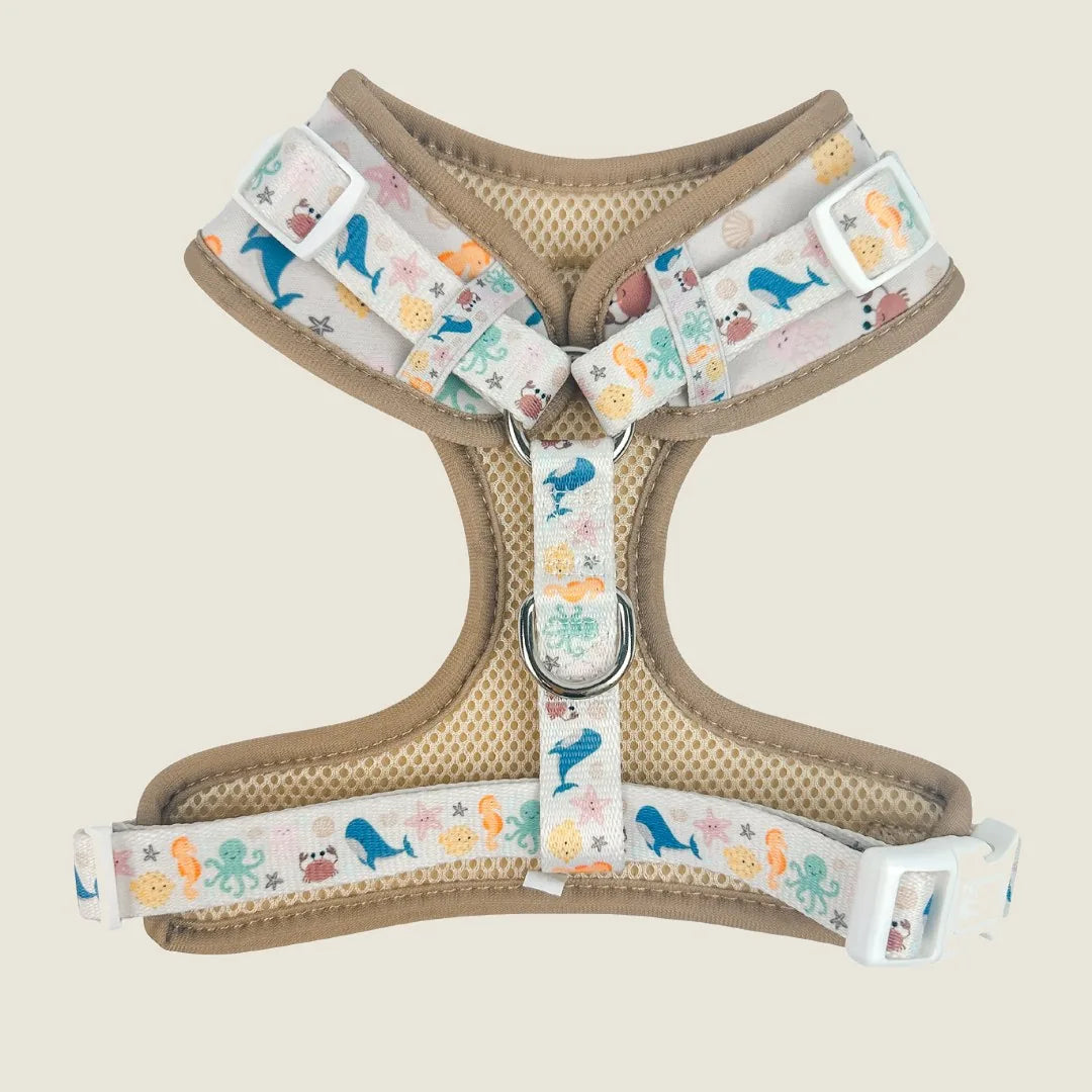 Adjustable dog harness in beige and patterned webbing, featuring marine life designs, made of soft neoprene and breathable...