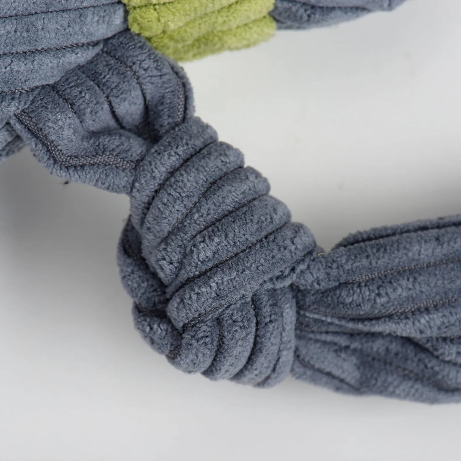 Close-up of the Seb Sloth Knottie® plush dog toy’s knotted blue fabric limbs, showcasing their durable and soft texture.