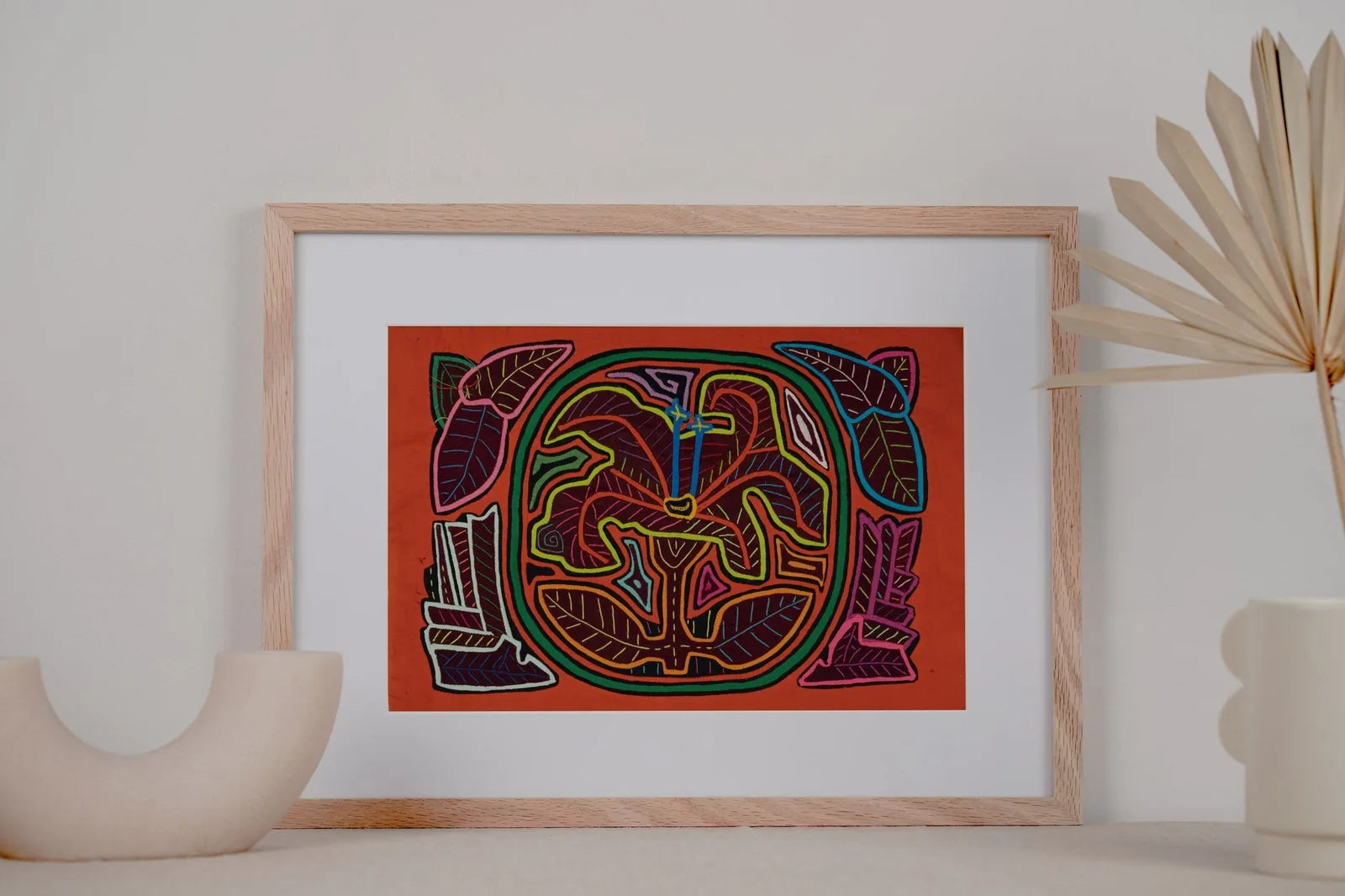 Hand-stitched Mola tapestry featuring a colorful shaggy puppy dog among floral and leaf patterns on a vibrant background.