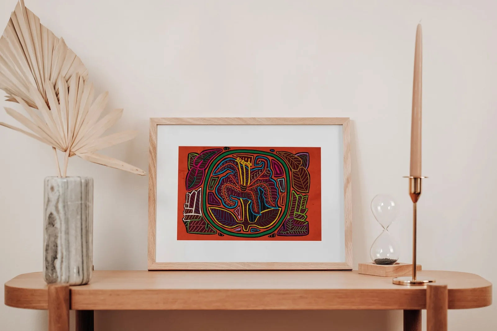 Hand-stitched colorful Mola tapestry featuring a shaggy puppy dog and flower design, framed in natural wood.