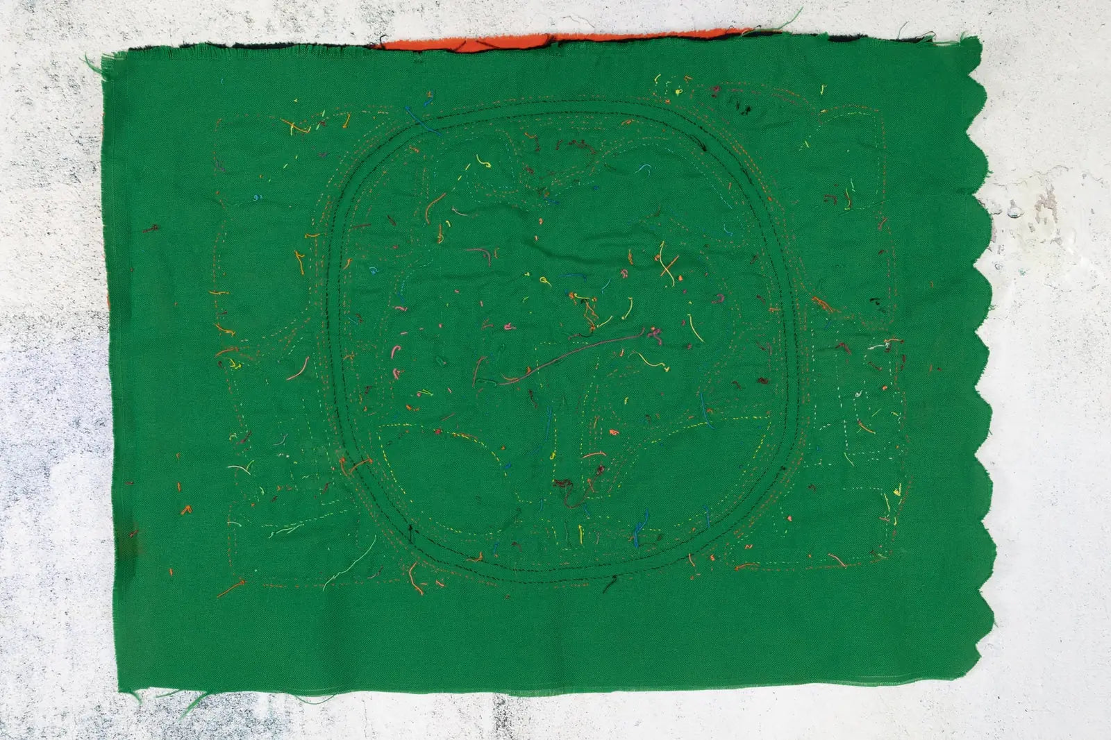 Hand-stitched green tapestry with colorful threads, depicting a shaggy puppy design inspired by Panama's Mola textile art.