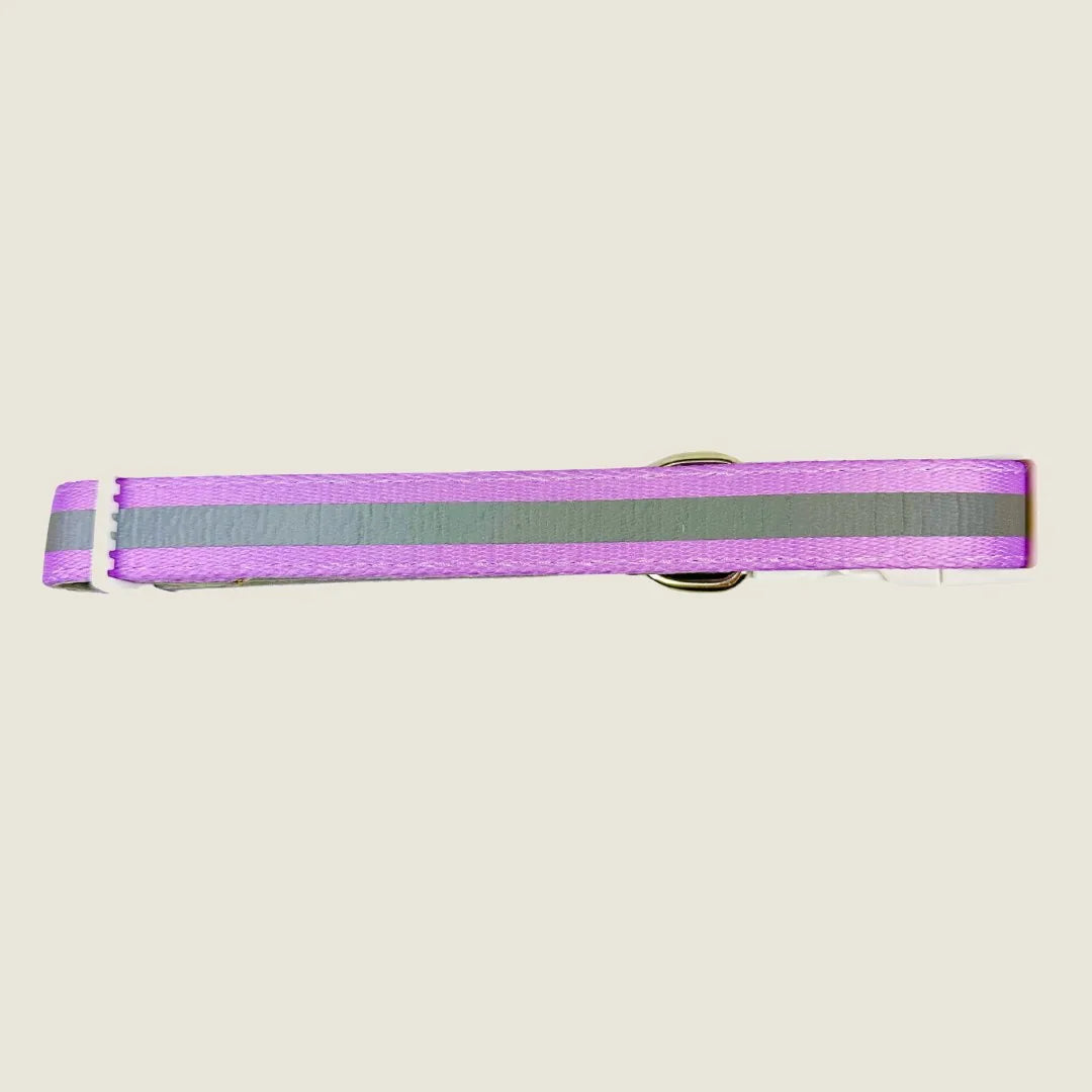 Adjustable pink dog collar with reflective gray stripes and a metal buckle, designed for comfort and visibility.