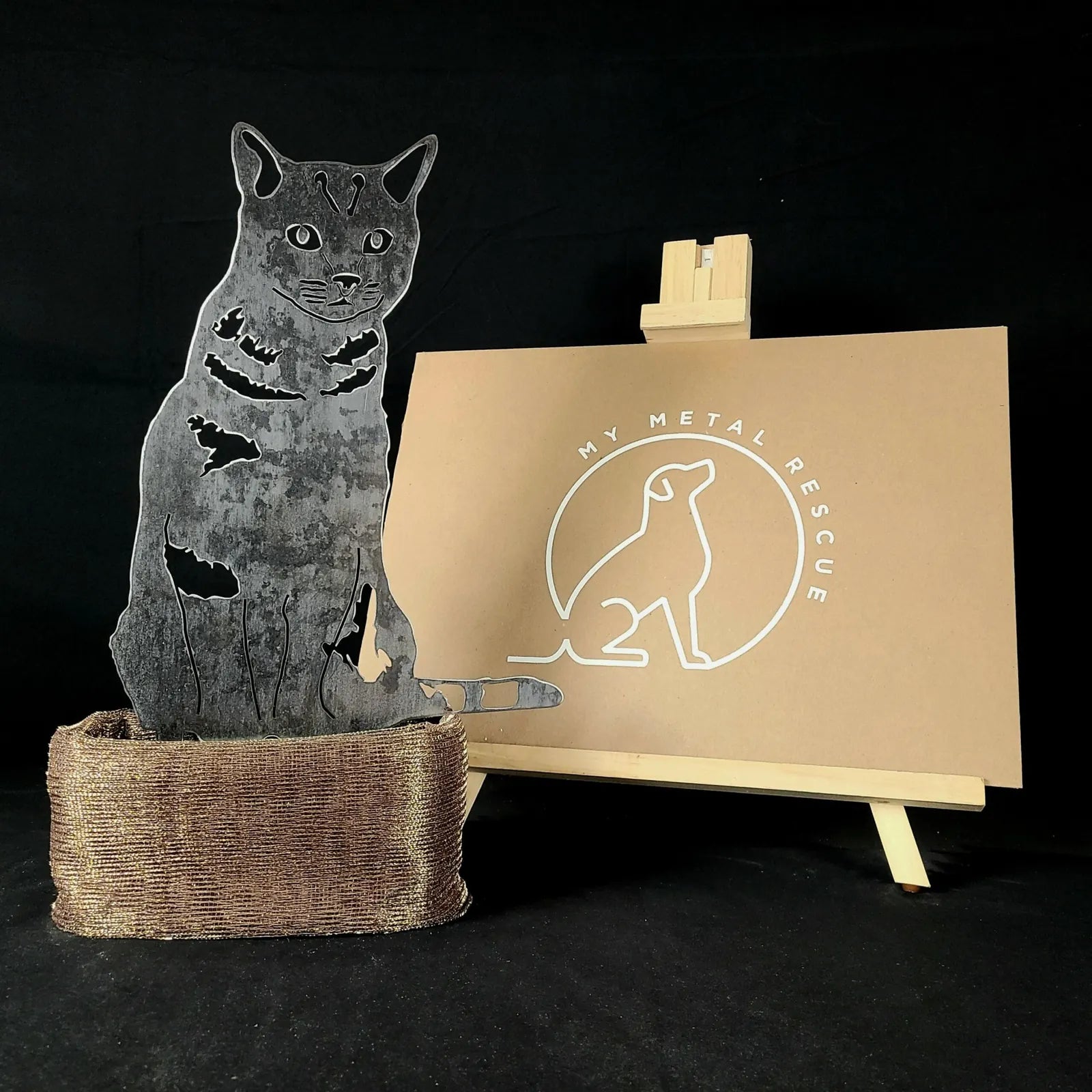 Shorthair tabby metal silhouette on a textured base, showcasing durable steel craftsmanship for outdoor decor.