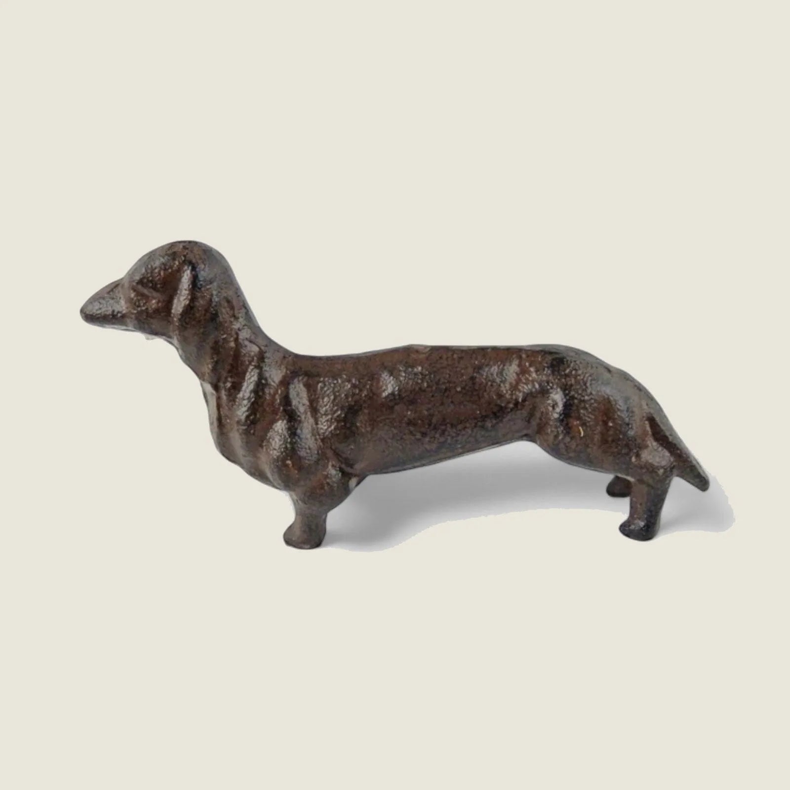 Handcrafted cast iron small dog figurine in a weathered black finish, perfect for rustic home decor accents.