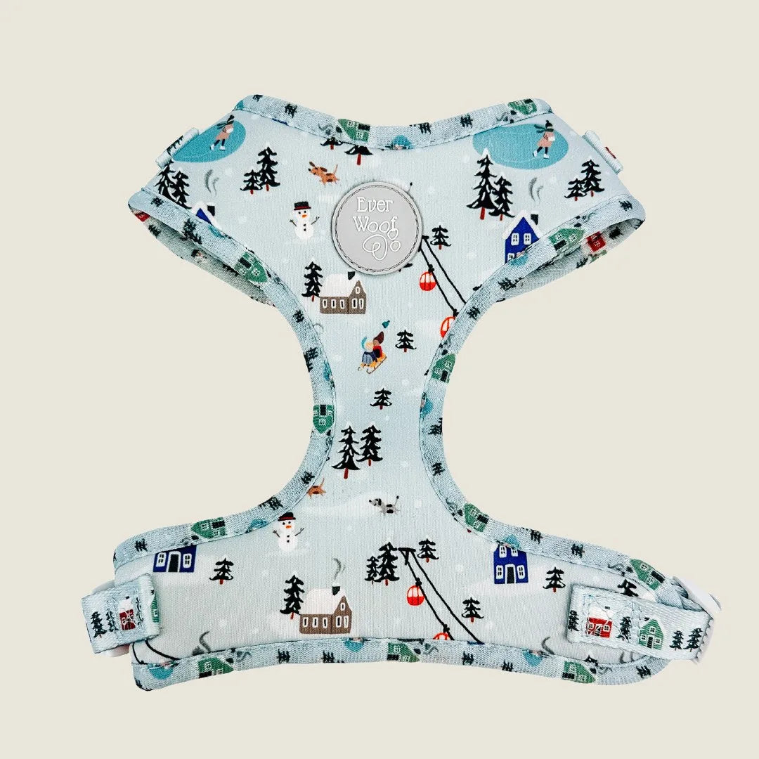 Snowy blue dog harness with holiday-themed prints, featuring adjustable straps for comfort and fit.