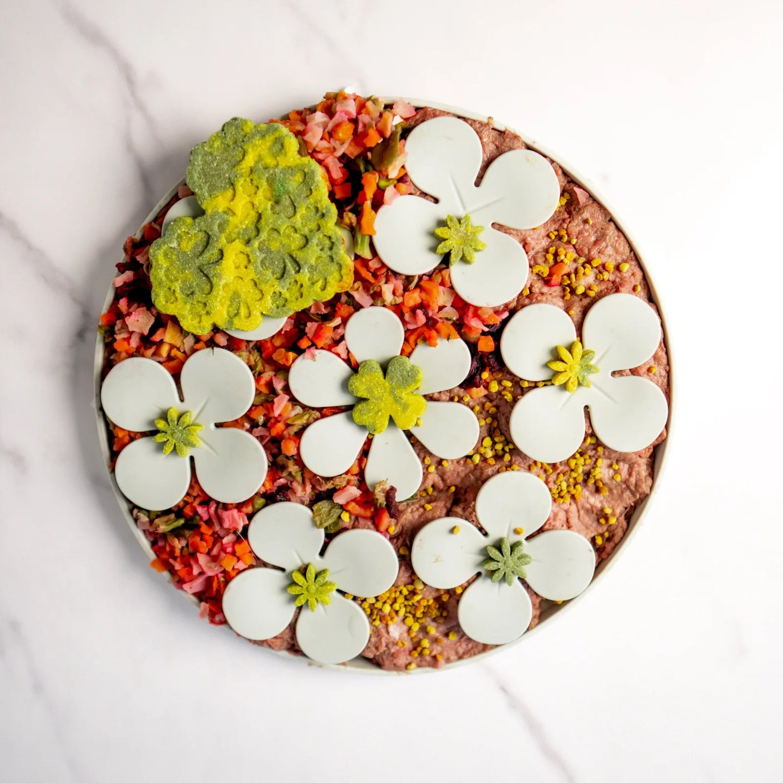 Colorful snuffle mat featuring floral designs in white, yellow, and green, with textured fabric for hiding treats.