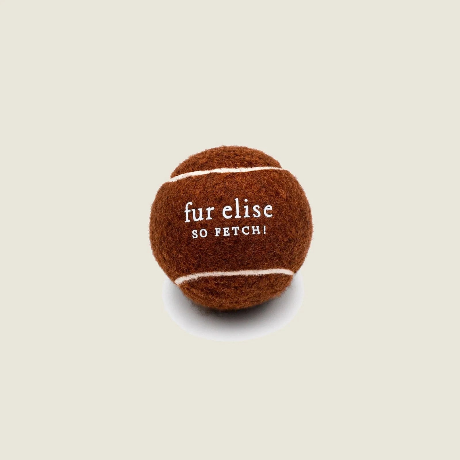 Brune tennis ball for dogs, featuring white stripes and "fur elise SO FETCH!" text, made from pet-safe materials.