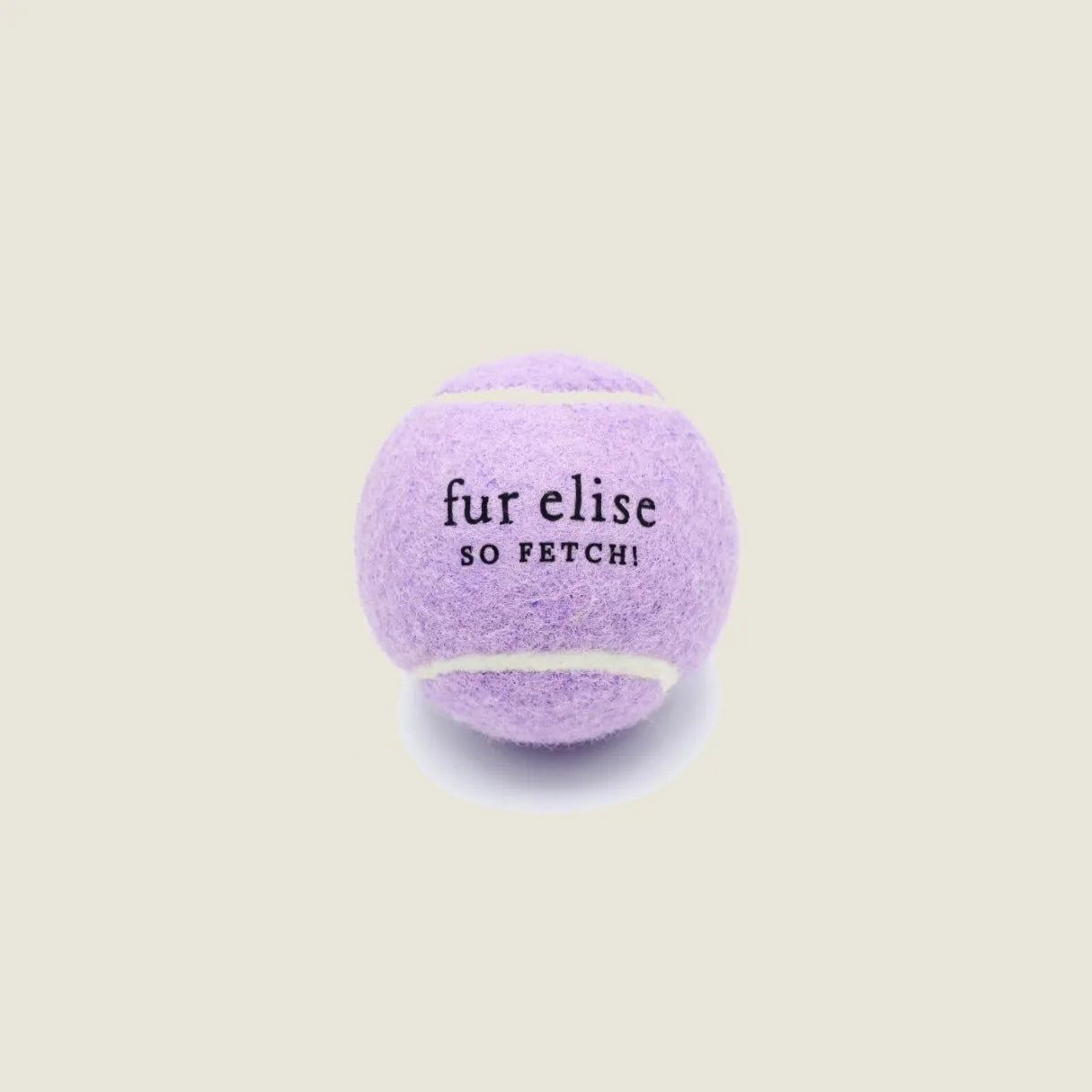 Lilac tennis ball for dogs with "fur elise" and "SO FETCH!" text, made from pet-safe felt and durable natural rubber core.