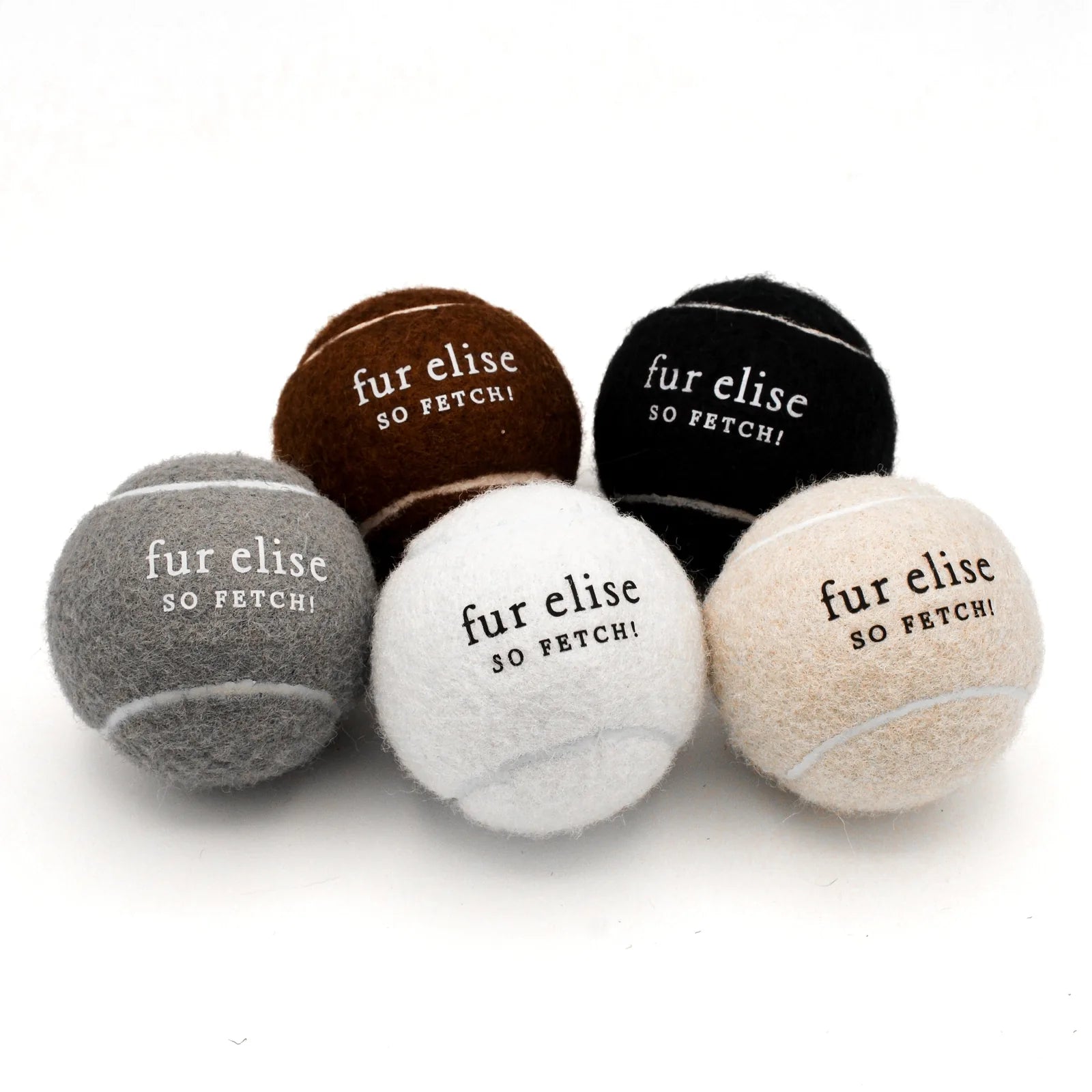 Stylish tennis balls for dogs in shades of black, brown, gray, white, and cream, featuring "fur elise SO FETCH!" branding.