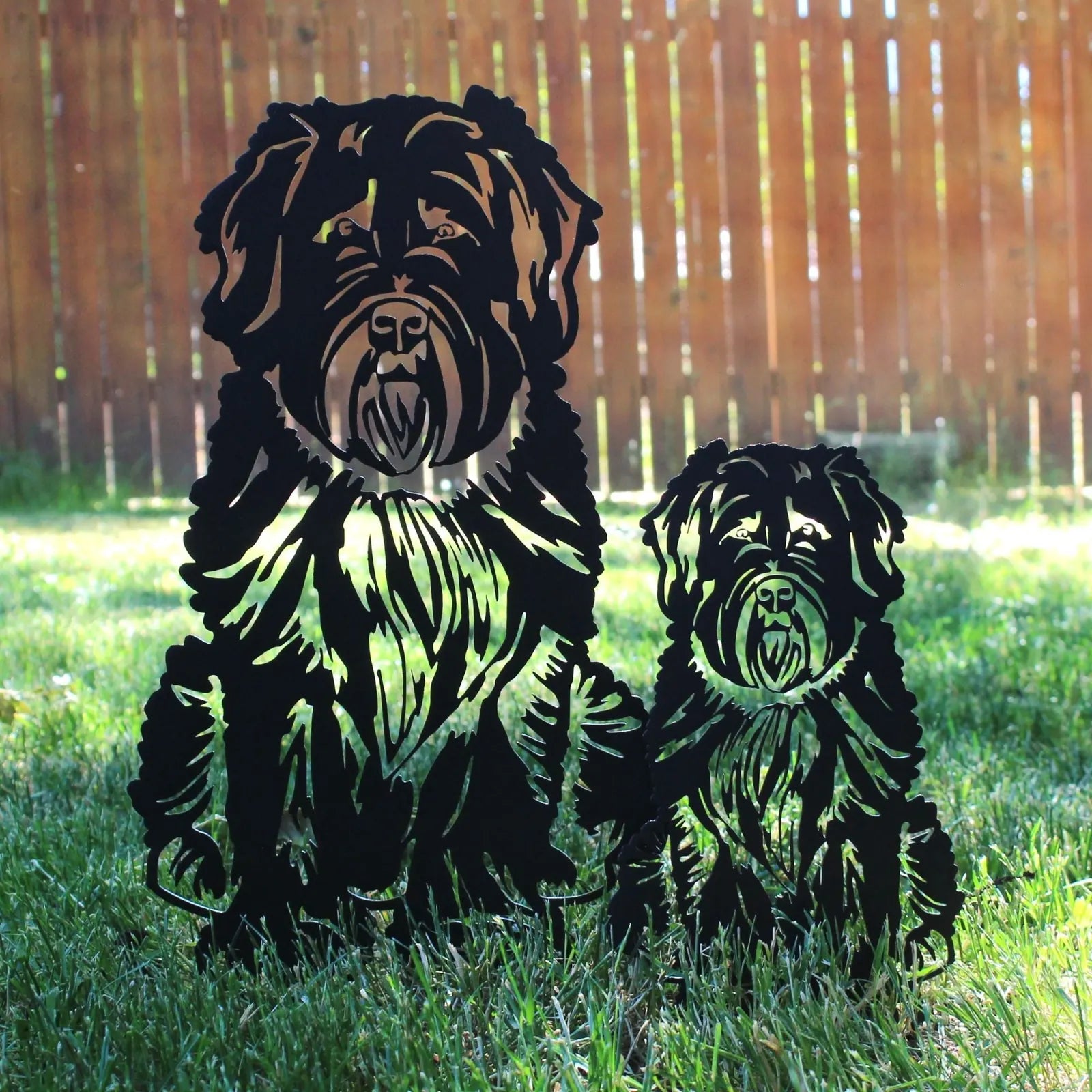 Soft Coated Wheaten Terrier metal silhouettes in black, showcasing a large and small dog, set against grass.