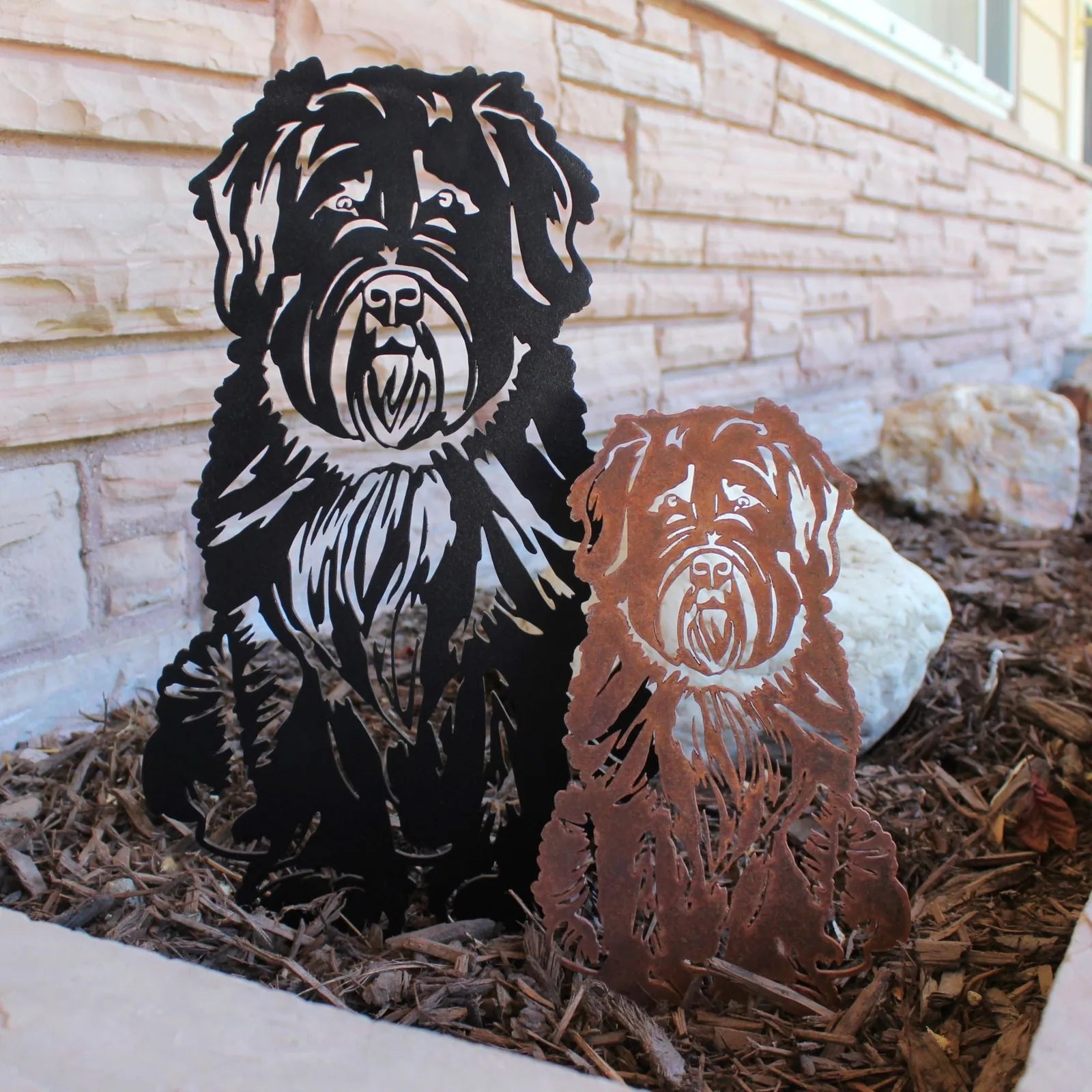 Black and Corten steel silhouette of a Soft Coated Wheaten Terrier, detailed design, placed in garden mulch.
