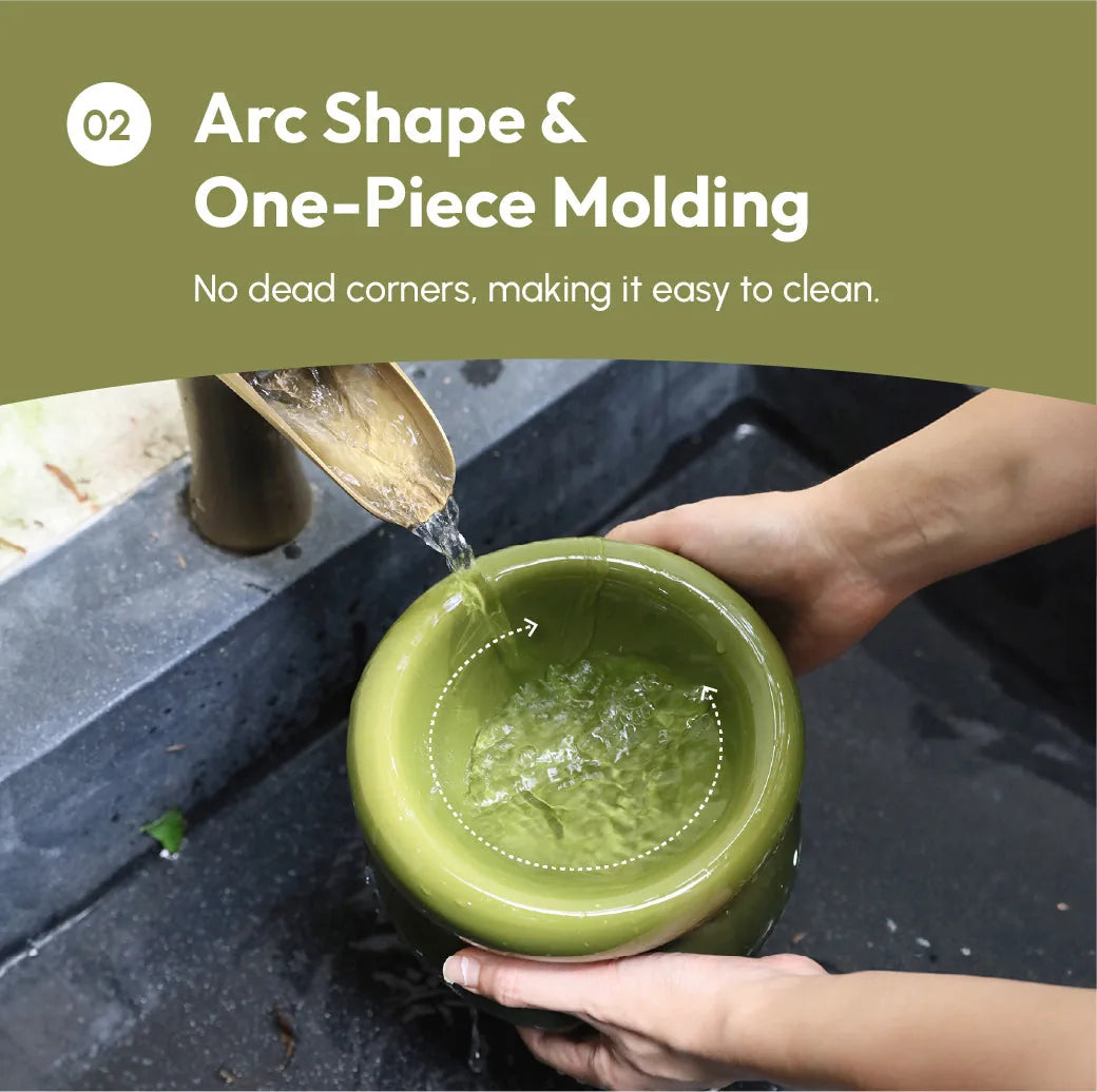 Avocado green pet bowl with a wide opening, being filled with water, showcasing its easy-clean one-piece design.