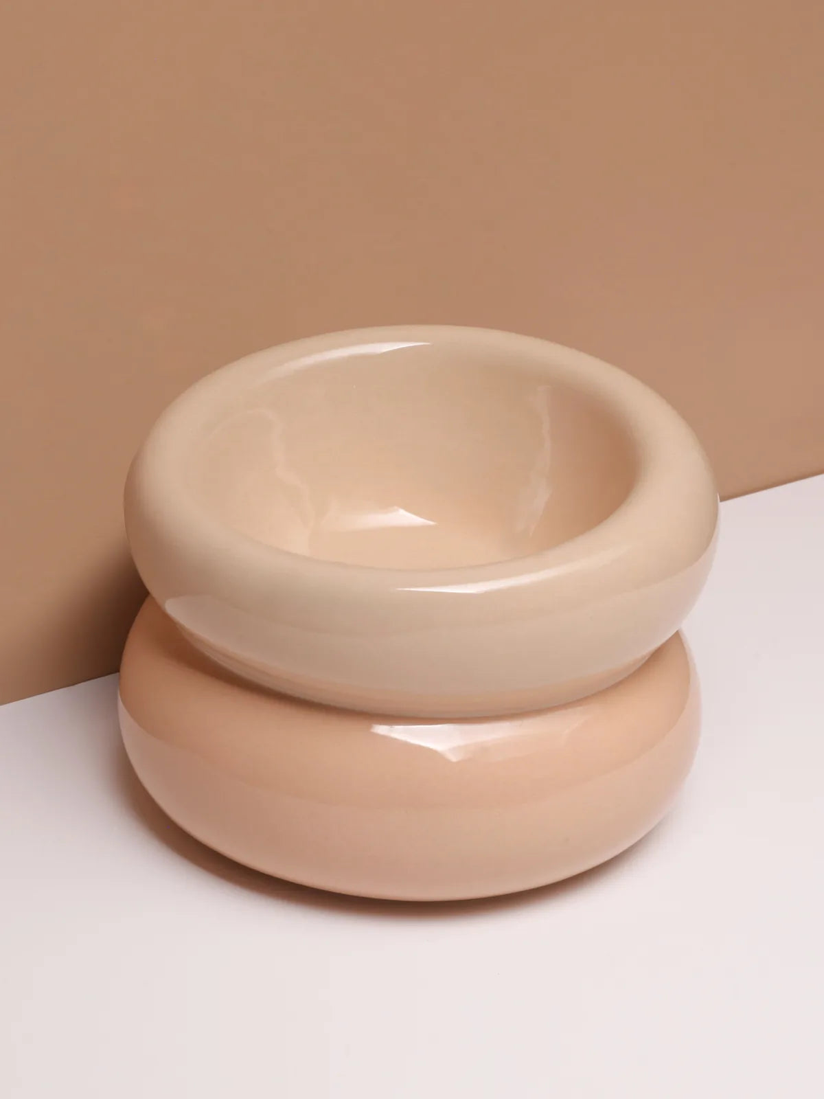 Cream beige pet bowl with a smooth, glossy finish and ergonomic diagonal opening, designed for comfortable feeding.