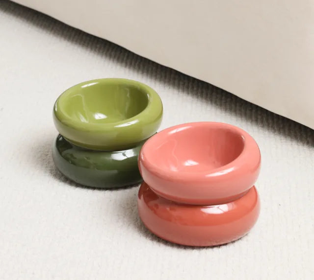 Soufflé pet bowl in rose pink with a glossy finish, designed for comfortable feeding, alongside a green bowl.