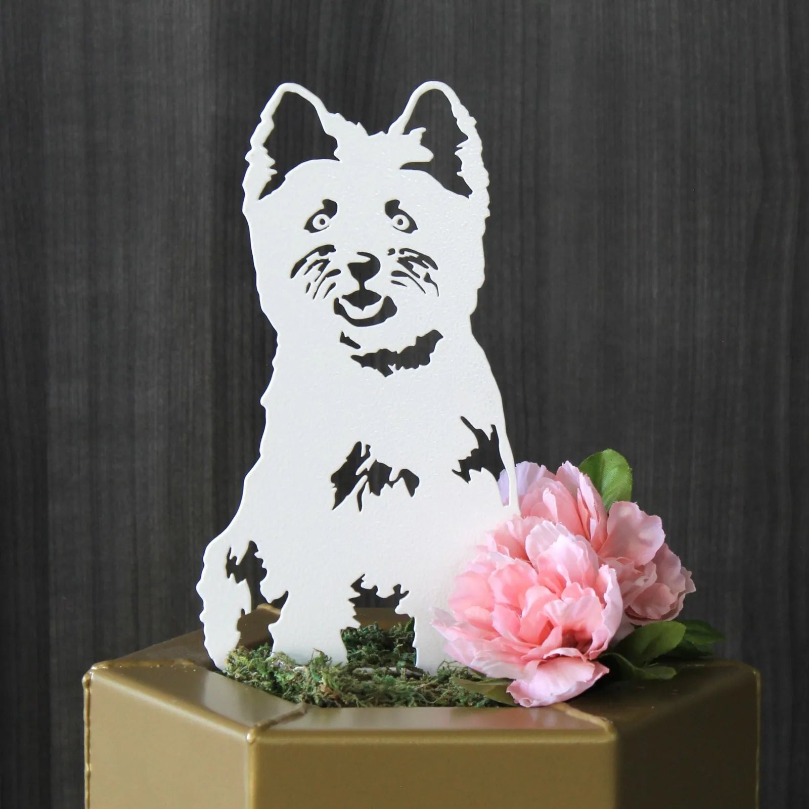 White metal silhouette of a West Highland White Terrier, adorned with pink flowers and moss, ideal for garden decor.
