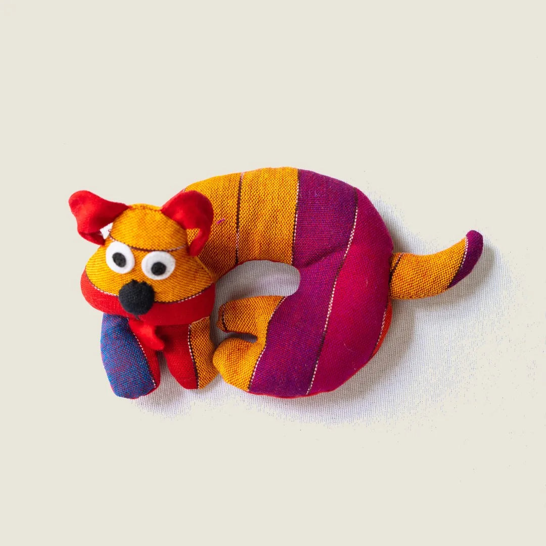 Colorful striped dog-shaped trivet in orange, purple, and red, handmade from fabric for cozy kitchen charm.