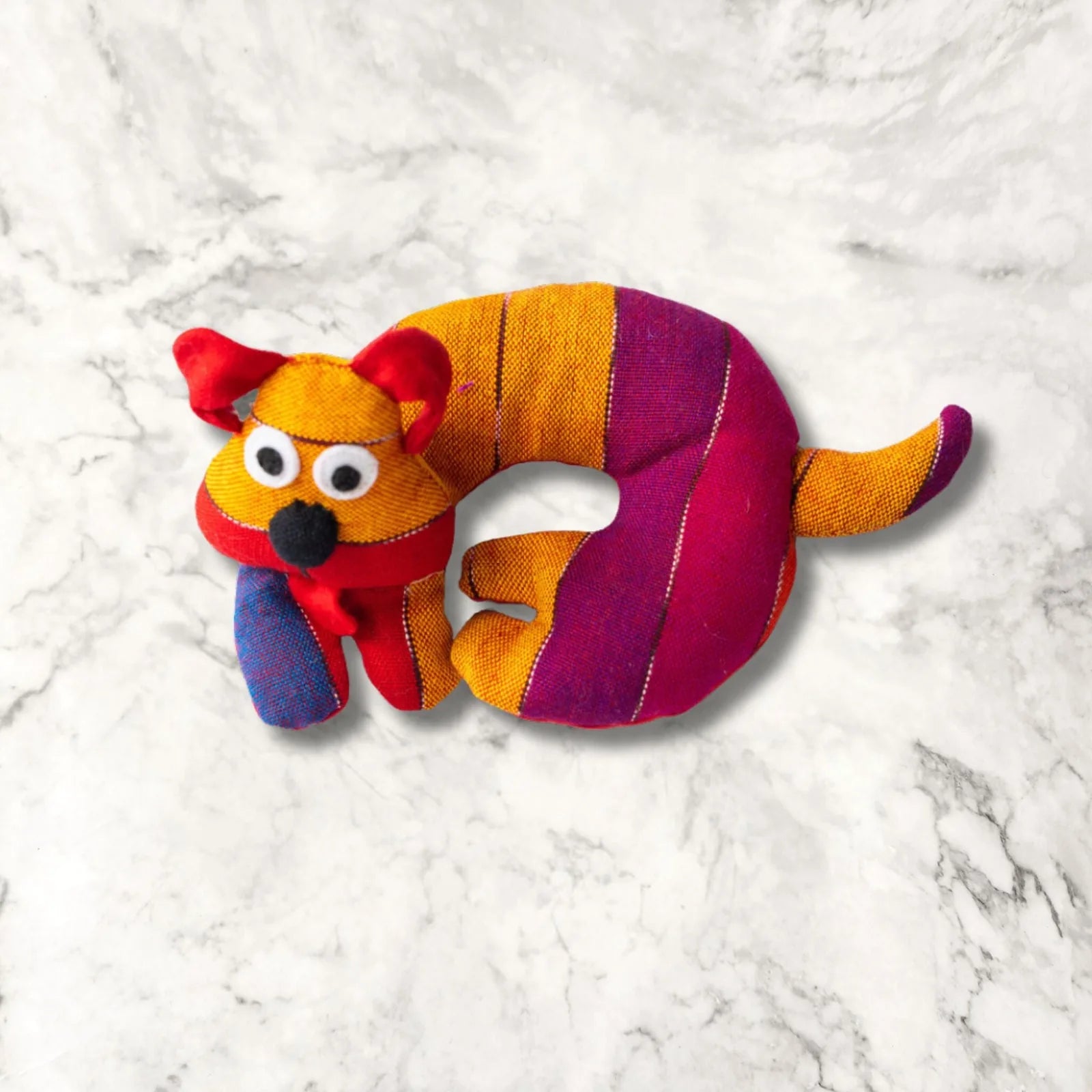 Colorful handmade dog-shaped trivet featuring striking red, orange, and purple stripes, perfect for adding warmth to your...