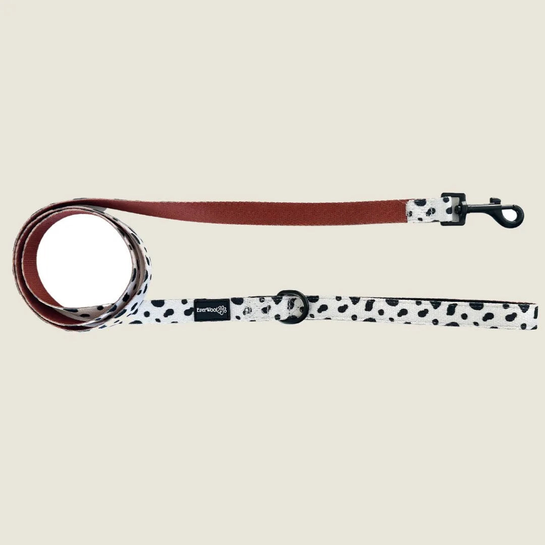 Spotted Ember leash with a brown handle, featuring a black and white spotted design, made of durable polyester webbing.