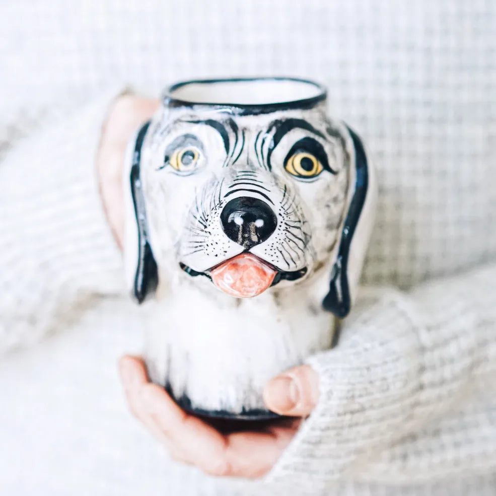 Handcrafted stoneware dog mug featuring a raised snout, ears, and tongue in gray and black accents.