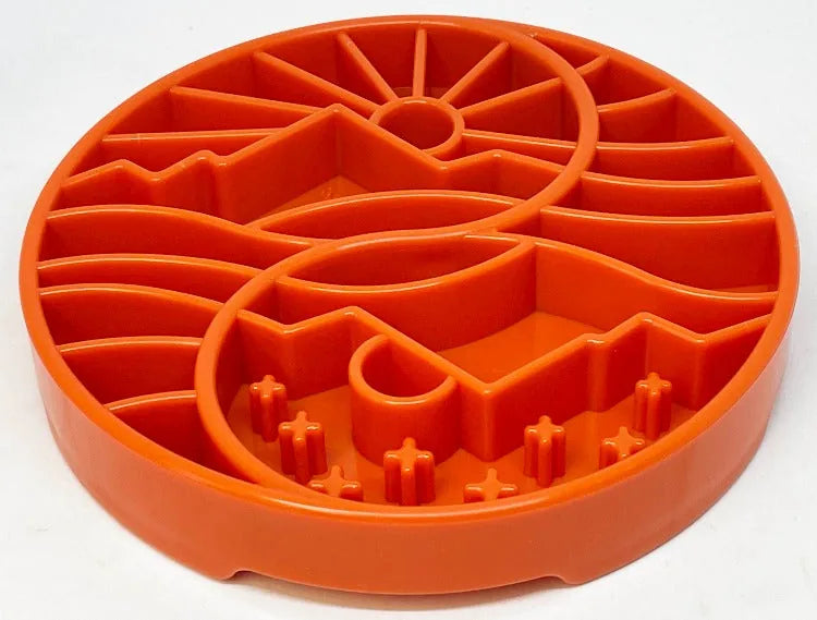 Orange shallow slow feeder dog bowl featuring a sun and moon design with raised ridges for mental stimulation.