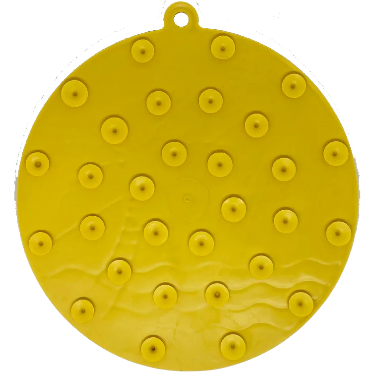 Bright yellow circular enrichment lick mat with textured ridges and suction cups, featuring a beach-inspired design.