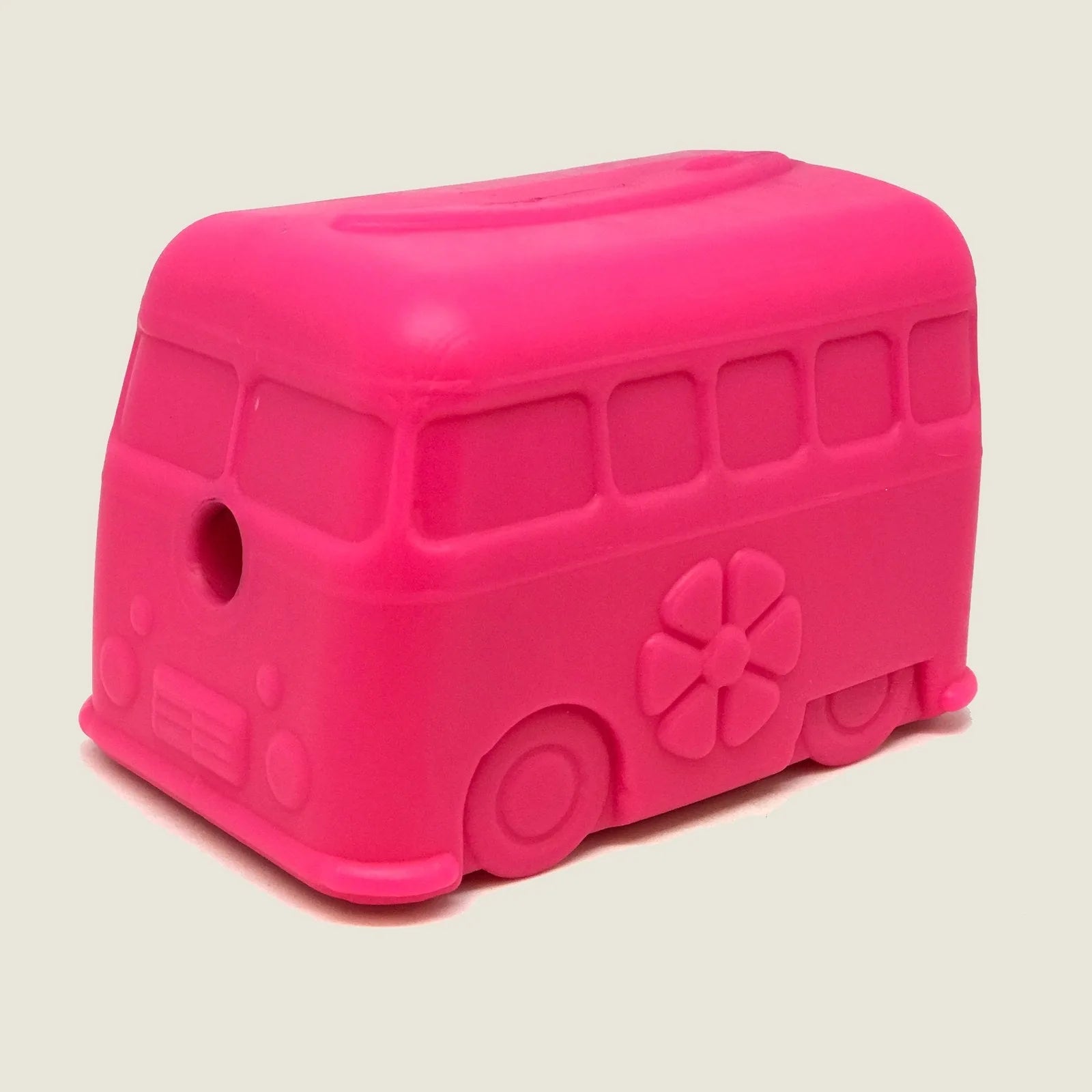 Bright pink retro van-shaped chew toy made of durable rubber, featuring a surfboard detail and treat dispenser hole.