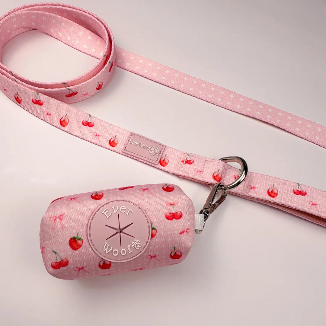 Pink Sweet Chérie Waste Bag by EverWoof with cherry pattern, attached to a matching leash featuring polka dots.