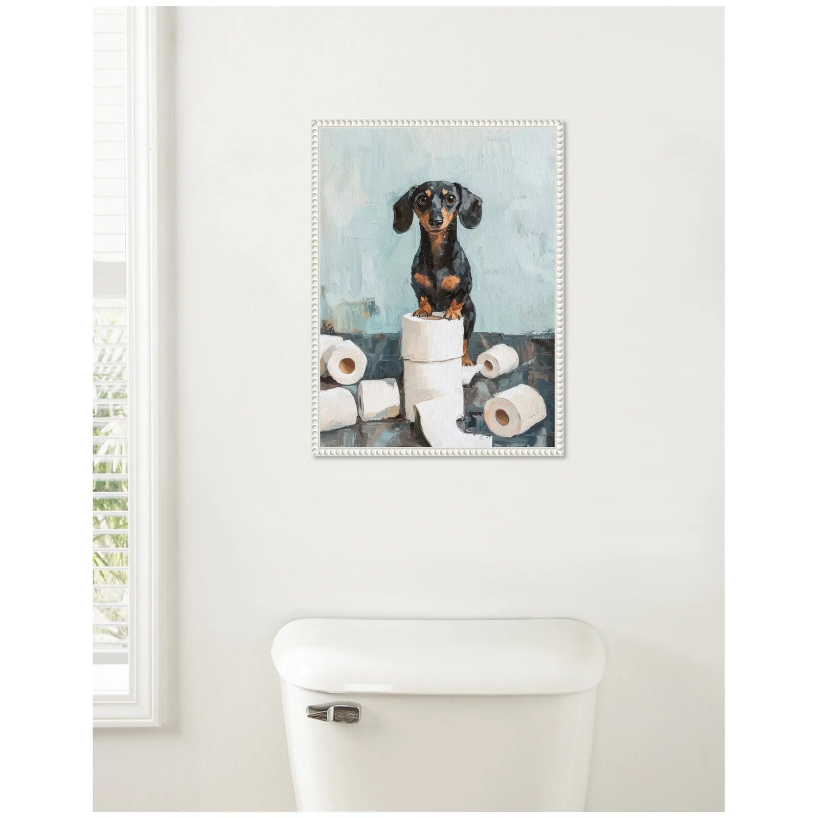 Dachshund standing on a toilet paper roll surrounded by more rolls, framed canvas art with teal background and beaded frame.