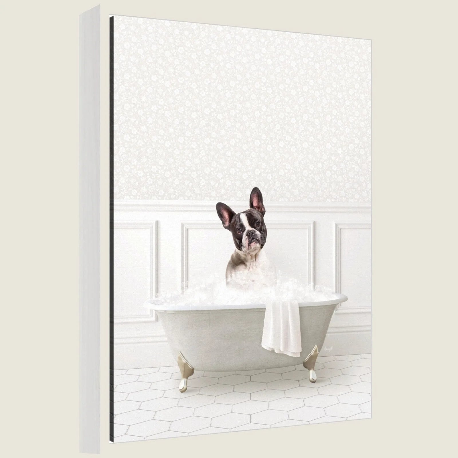 Charming French Bulldog relaxing in a white bathtub filled with bubbles, set against a soft patterned wall.