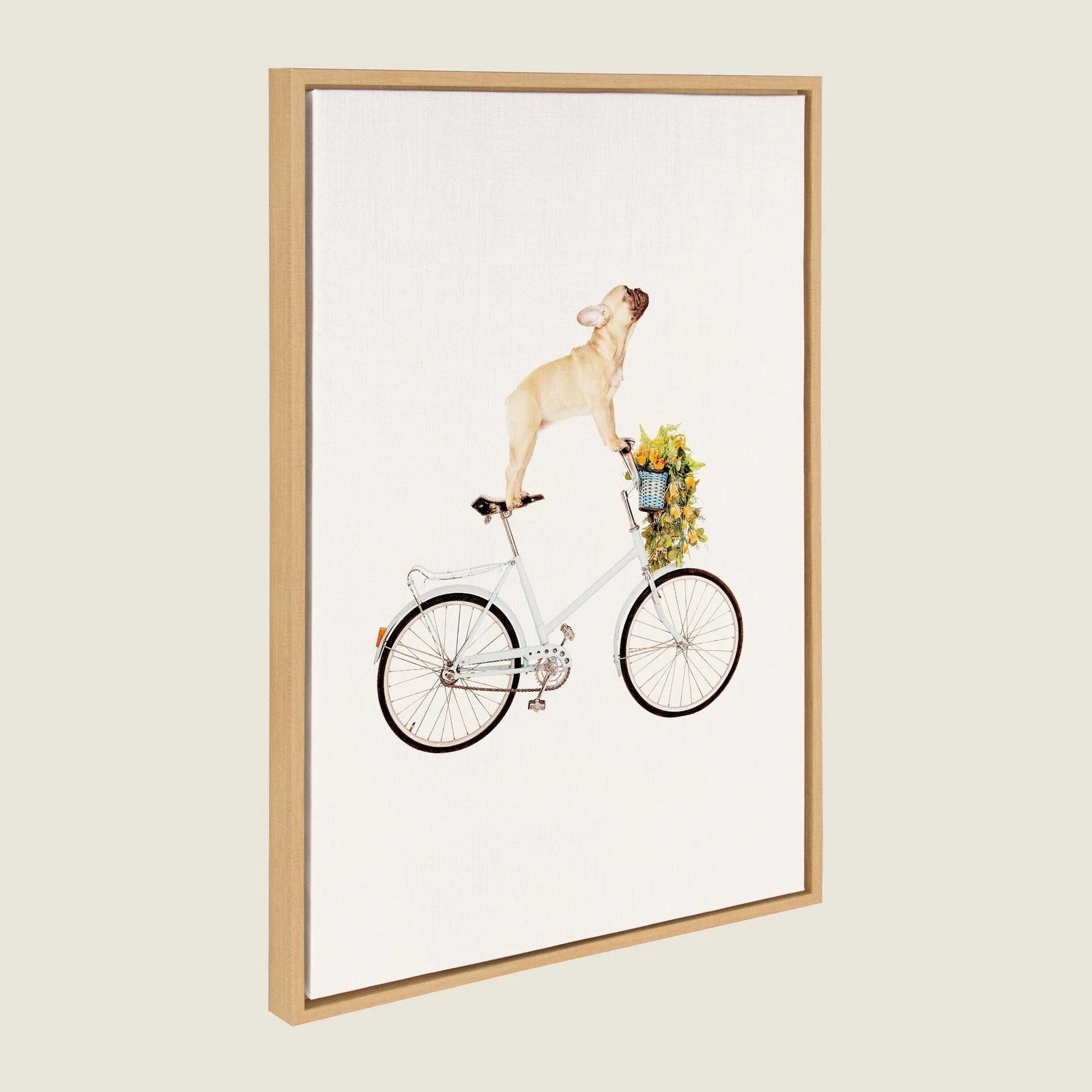 Playful canvas art of a French Bulldog standing on a light blue bicycle with a flower-filled basket, framed in natural wood.