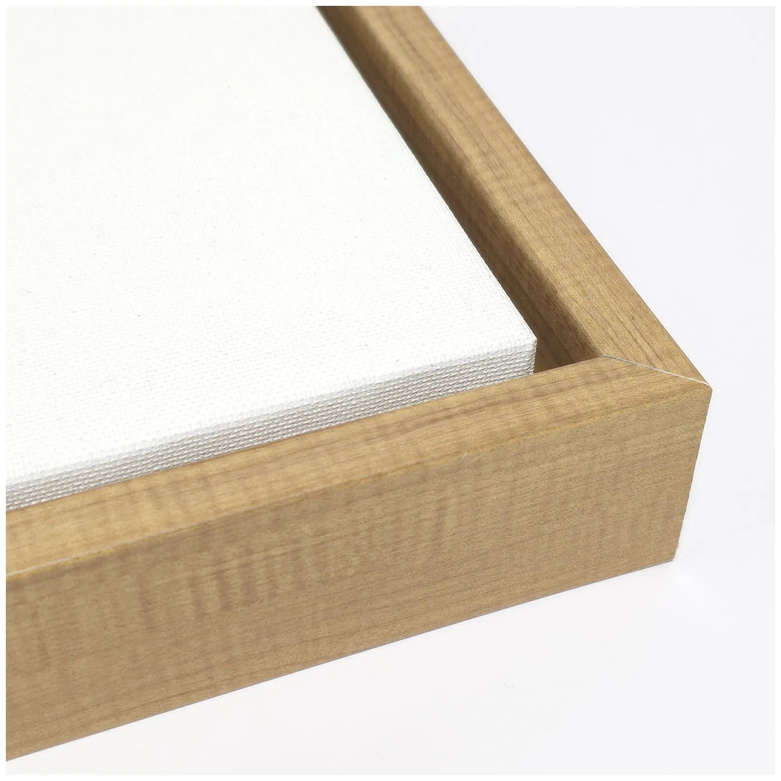 Close-up of a natural wood frame with a textured canvas wrapped around the edges, showcasing quality craftsmanship.