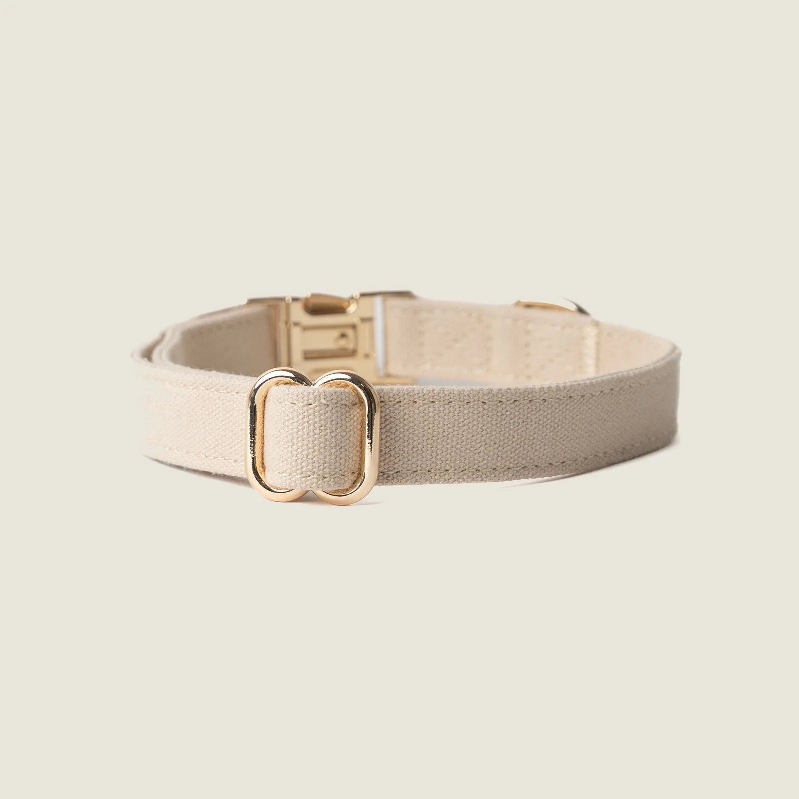 Tan canvas dog collar by FURLOU featuring gold hardware, offering a lightweight and breathable design for comfort.