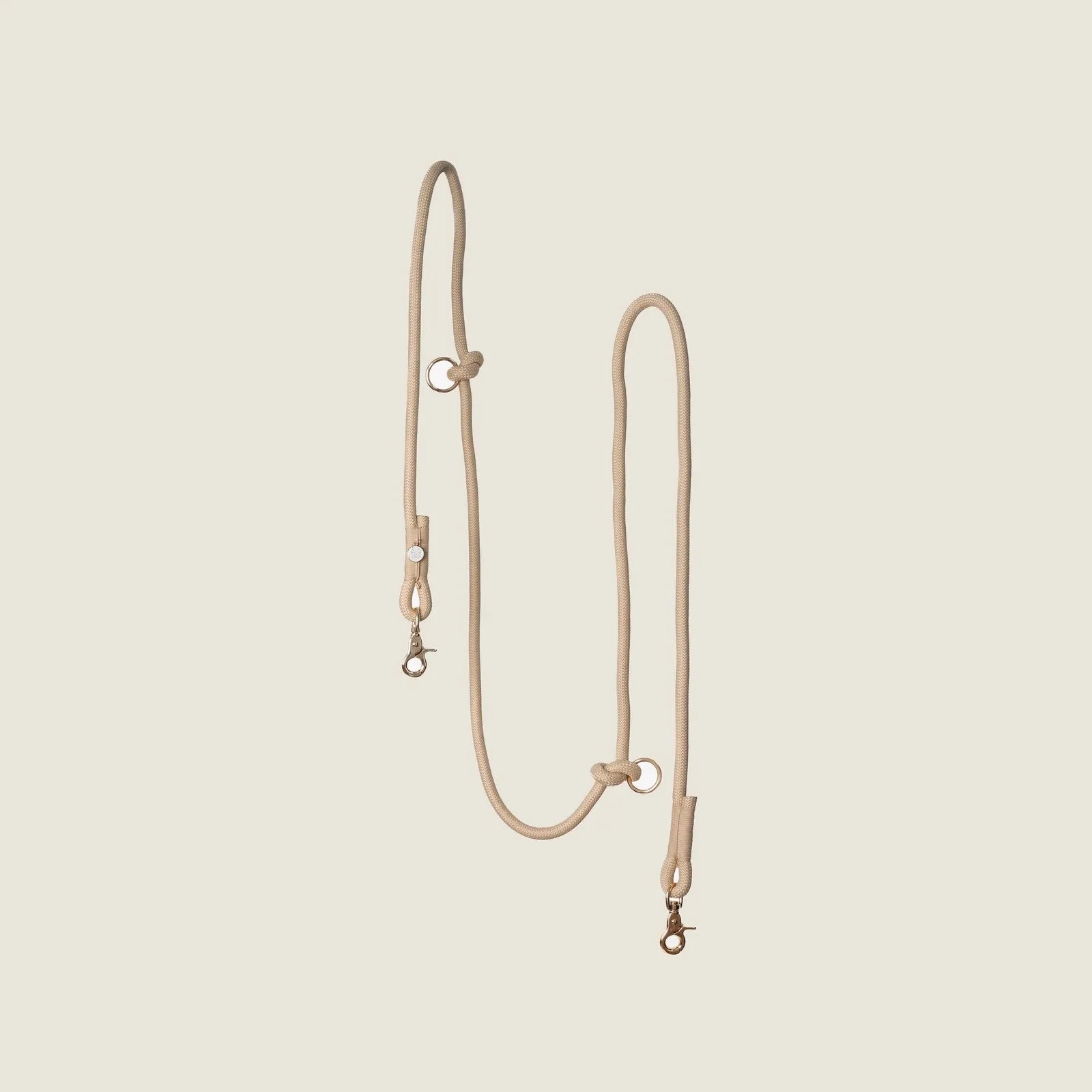 Tan hands-free braided leash from FURLOU, featuring durable material and adjustable design for convenience during walks.