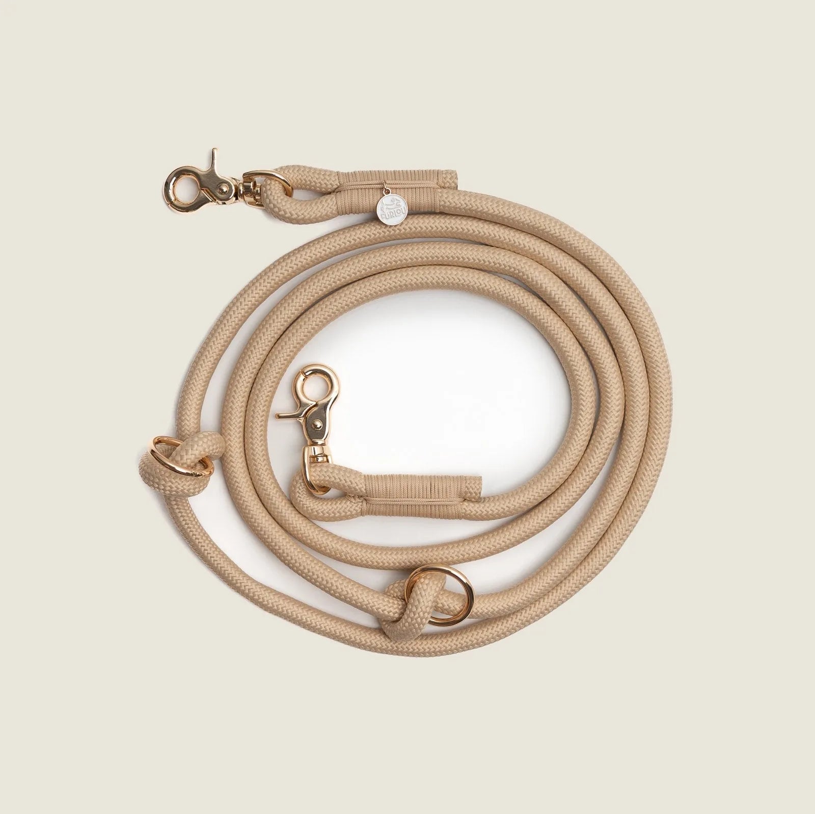 Tan braided hands-free leash by FURLOU featuring durable material and gold hardware, perfect for walking your dog.