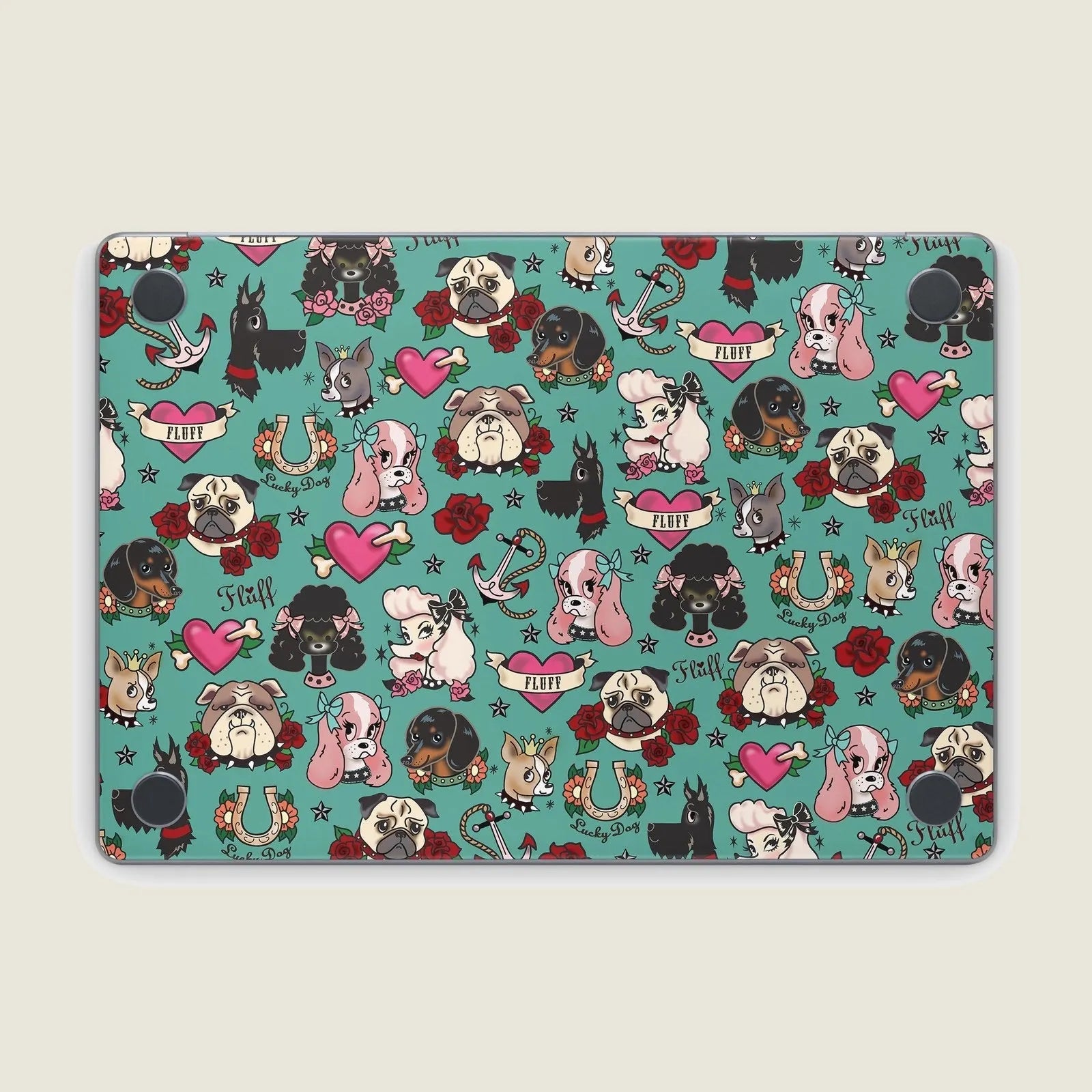 Tattoo Dogs MacBook skin featuring a colorful pattern of various dog illustrations, roses, and playful designs on a teal b...