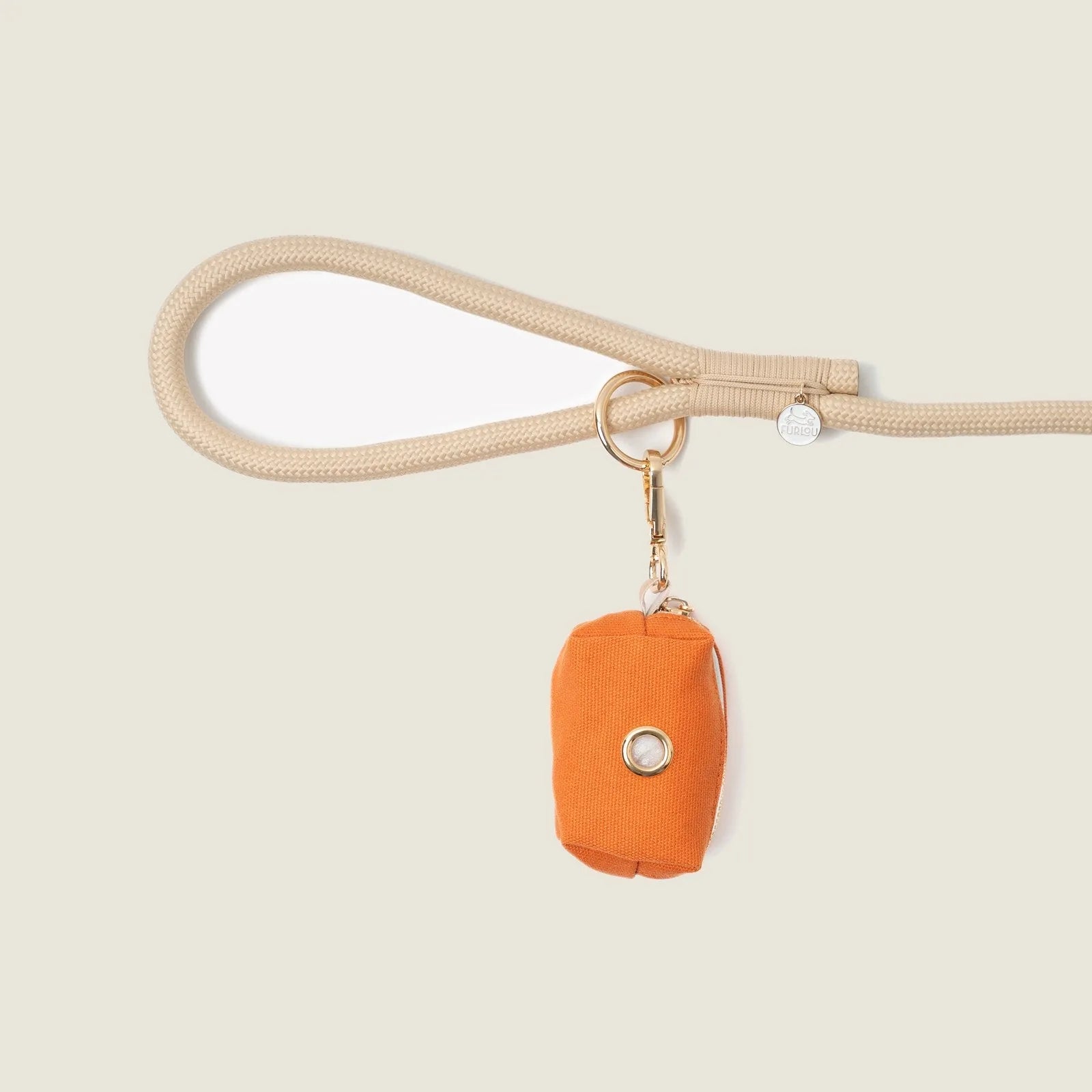 Terracotta poop bag holder by FURLOU attached to a beige leash, featuring a secure clip and simple design.